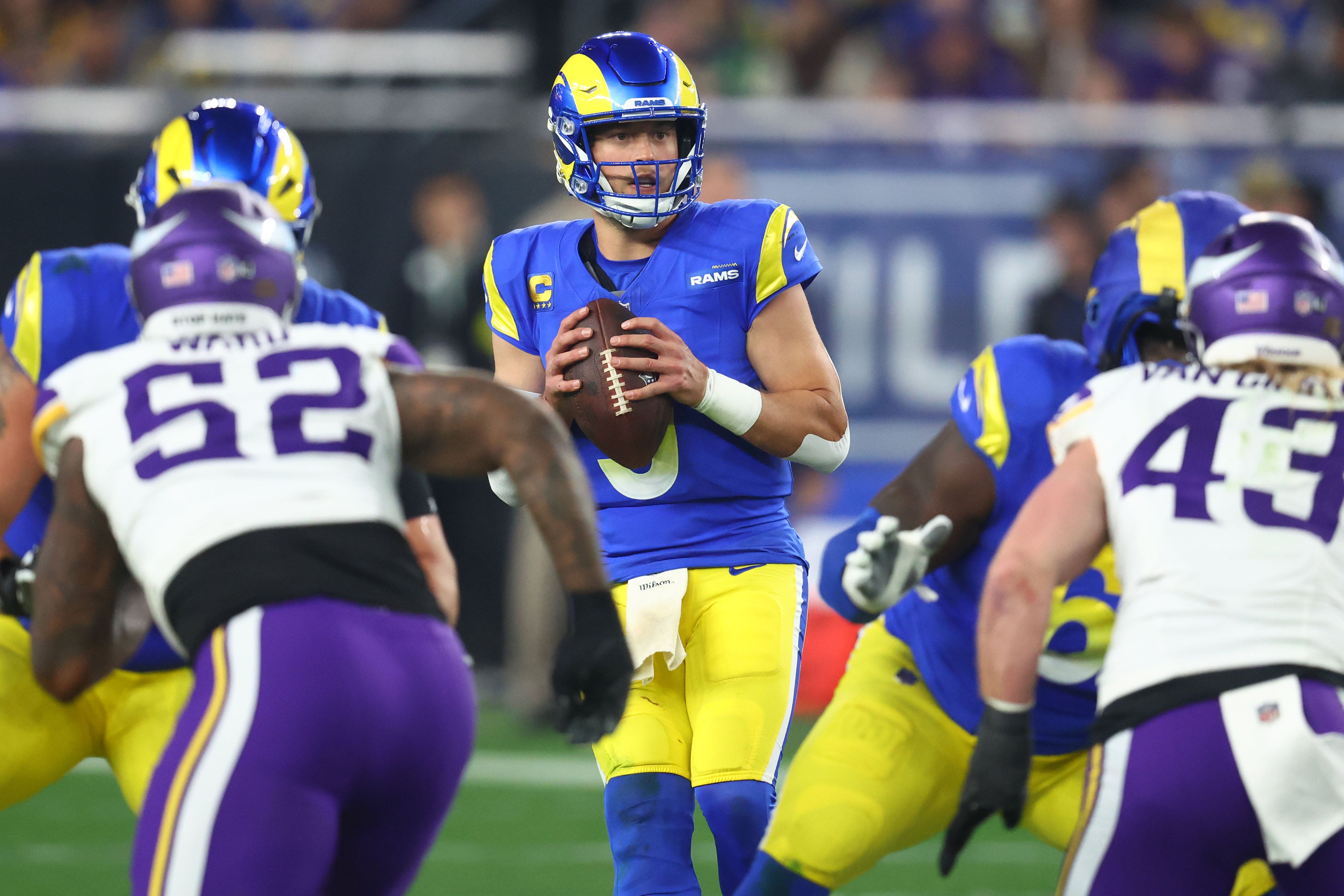 Jan 13, 2025; Glendale, AZ, USA; Los Angeles Rams quarterback Matthew Stafford (9) drops back to pass against the Minnesota Vikings during the second half in an NFC wild card game at State Farm Stadium.