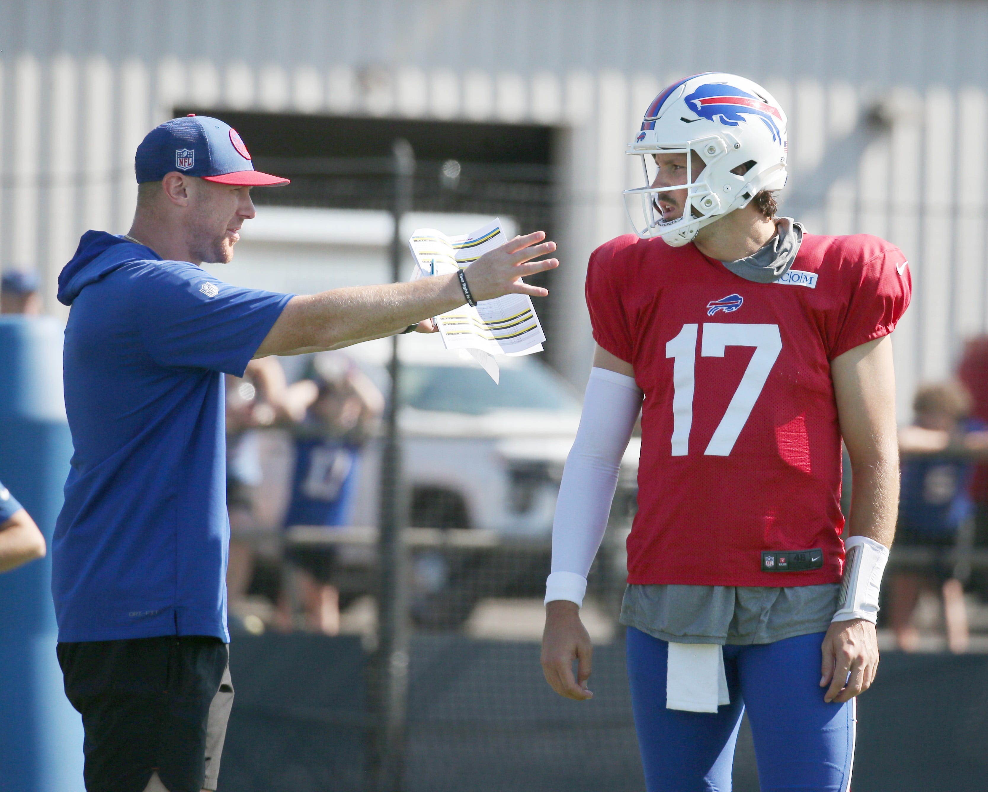 Bills quarterback Josh Allen talks with offensive coordinator Joe Brady between drills.