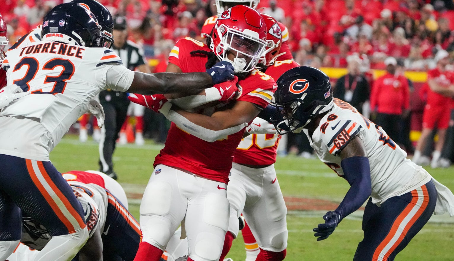Kansas City Chiefs running back Keaontay Ingram (30) runs the ball as Chicago Bears cornerback Ro Torrence (33) defends during the game at GEHA Field at Arrowhead Stadium.