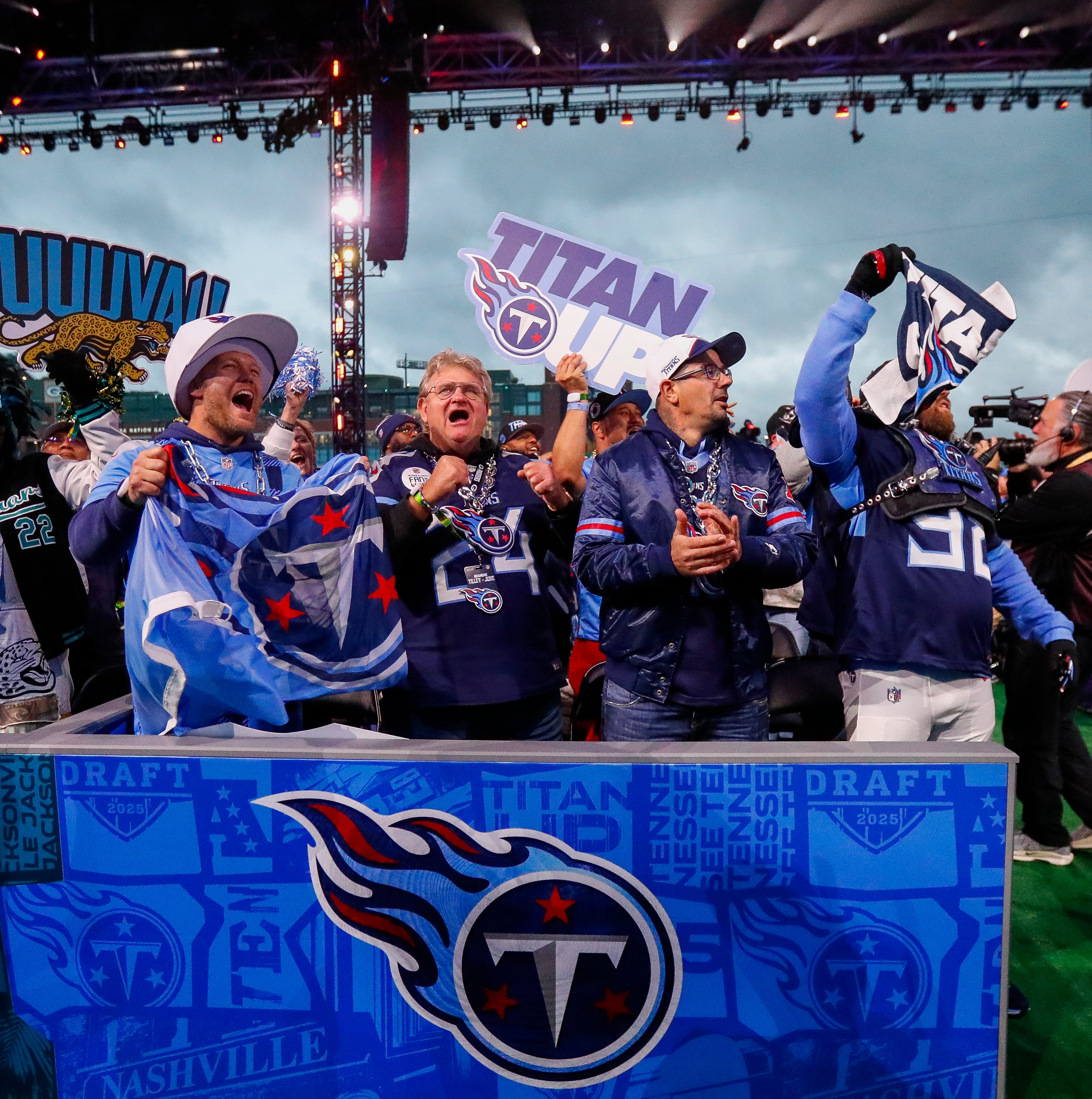 Apr 25, 2025; Green Bay, WI, USA; Tennessee Titans fans celebrate as former Titans linebacker Keith Bulluck (not shown) comes on stage to announce the team’s selection with the 52nd overall pick during the 2025 NFL Draft at Lambeau Field. Mandatory Credit: Tork Mason/USA Today Network via Imagn Images