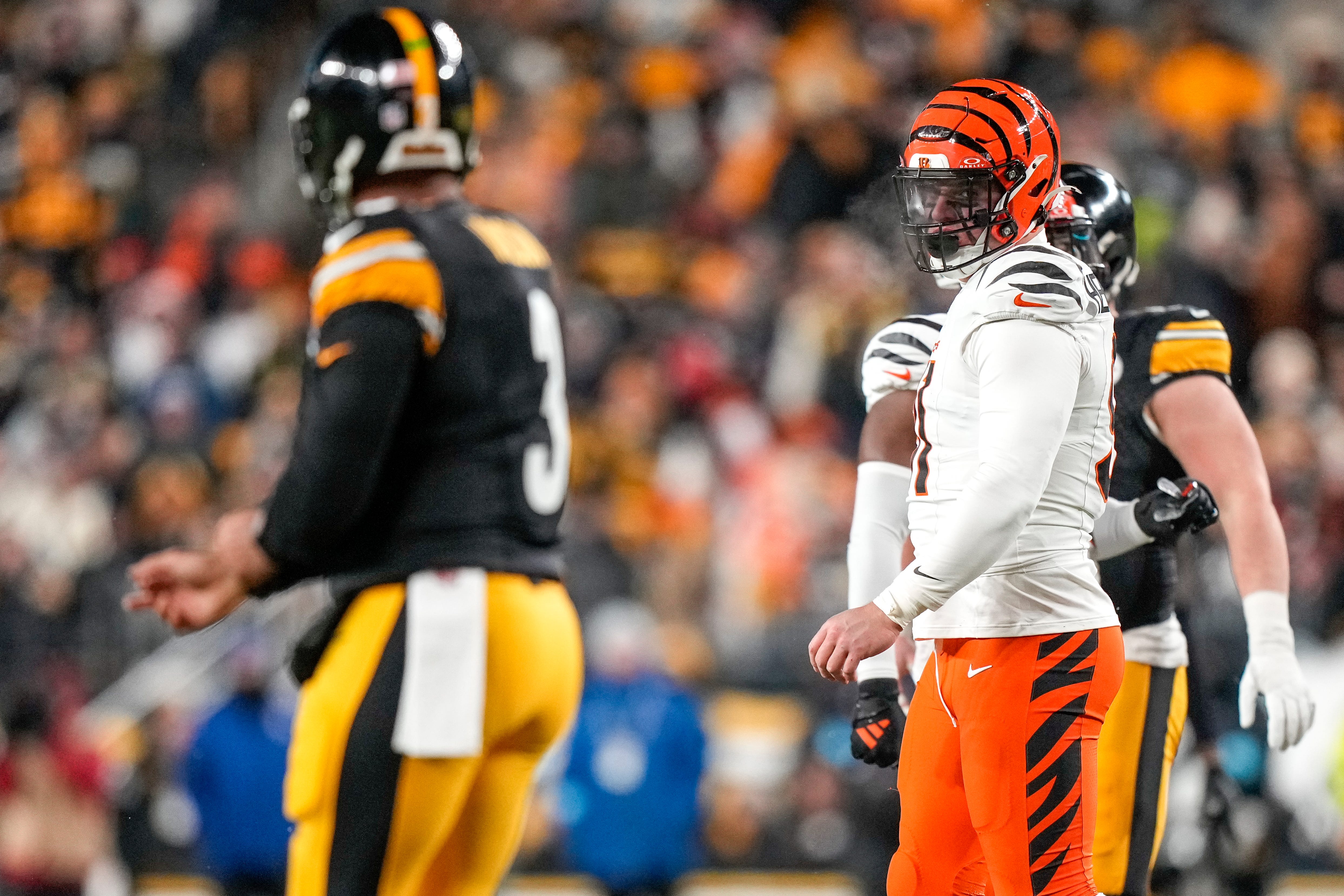 Cincinnati Bengals defensive end Trey Hendrickson (91) stares down Pittsburgh Steelers quarterback Russell Wilson (3) between plays in the first quarter of the NFL Week 18 game between the Pittsburgh Steelers and the Cincinnati Bengals at Acrisure Stadium in Pittsburgh on Saturday, Jan. 4, 2025.