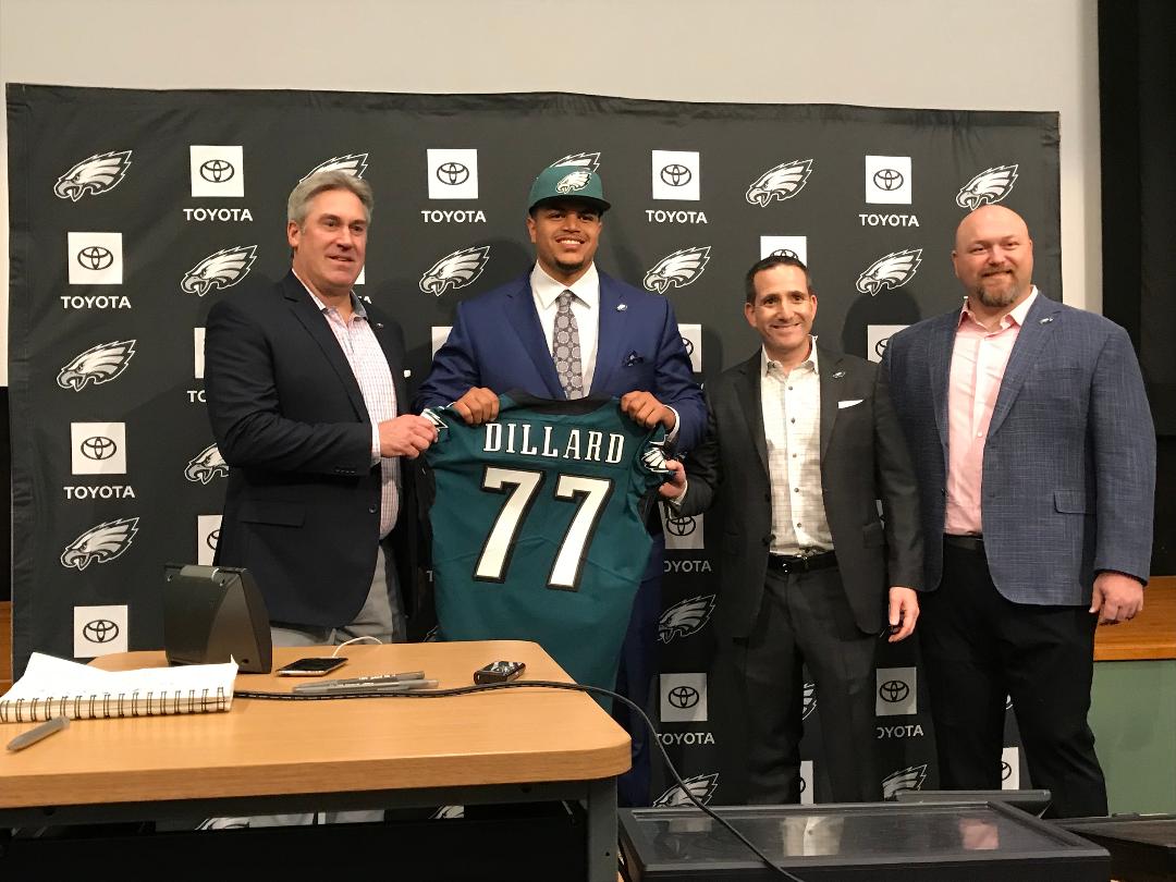 Eagles' first-round draft pick, Andre Dillard, shows off his jersey as he's flanked by head coach Doug Pederson, left, executive VP Howie Roseman and VP of player personnel Joe Douglas. Andre Dillard.