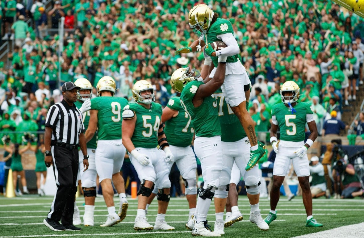 Notre Dame offensive lineman Aamil Wagner (59) throws wide receiver Jaden Greathouse (1) into the air after a Greathouse touchdown during a NCAA college football game between Notre Dame and Louisville at Notre Dame Stadium on Saturday, Sept. 28, 2024, in South Bend.