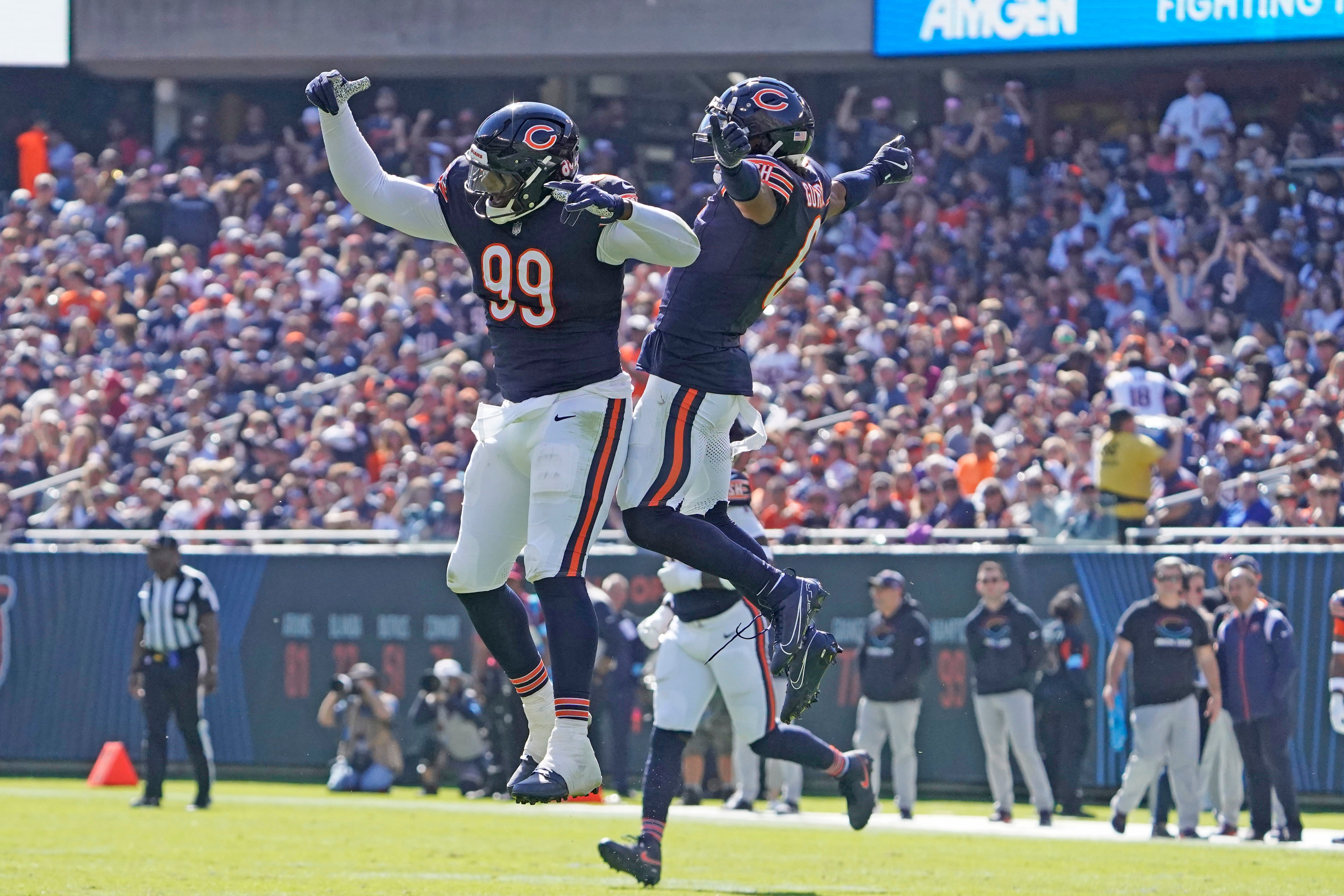 Oct 6, 2024; Chicago, Illinois, USA; Chicago Bears cornerback Kyler Gordon (6) and defensive tackle Gervon Dexter Sr. (99) celebrate a sack of Carolina Panthers quarterback Andy Dalton (14) during the first half at Soldier Field.