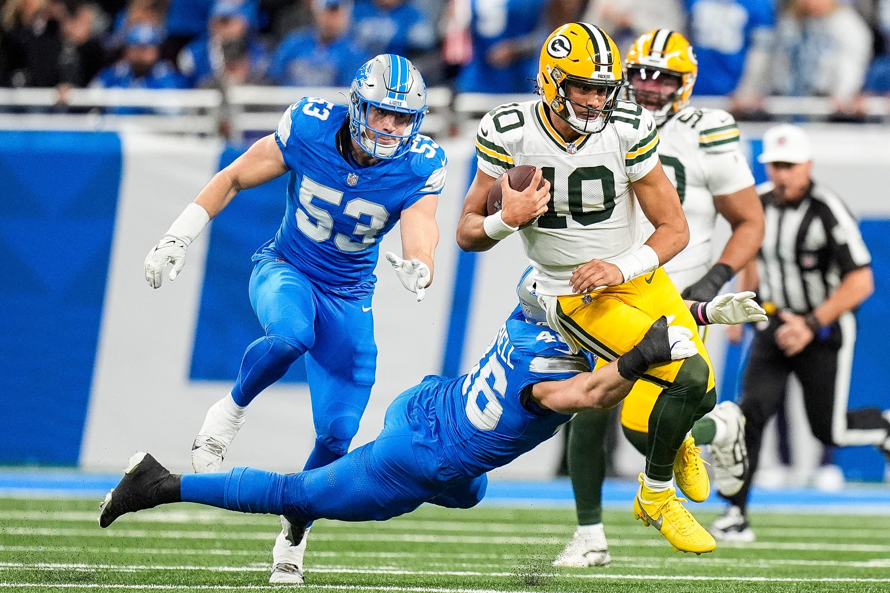 Detroit Lions linebacker Jack Campbell (46) tackles Green Bay Packers quarterback Jordan Love (10) during the first half at Ford Field in Detroit on Thursday, Dec. 5, 2024.