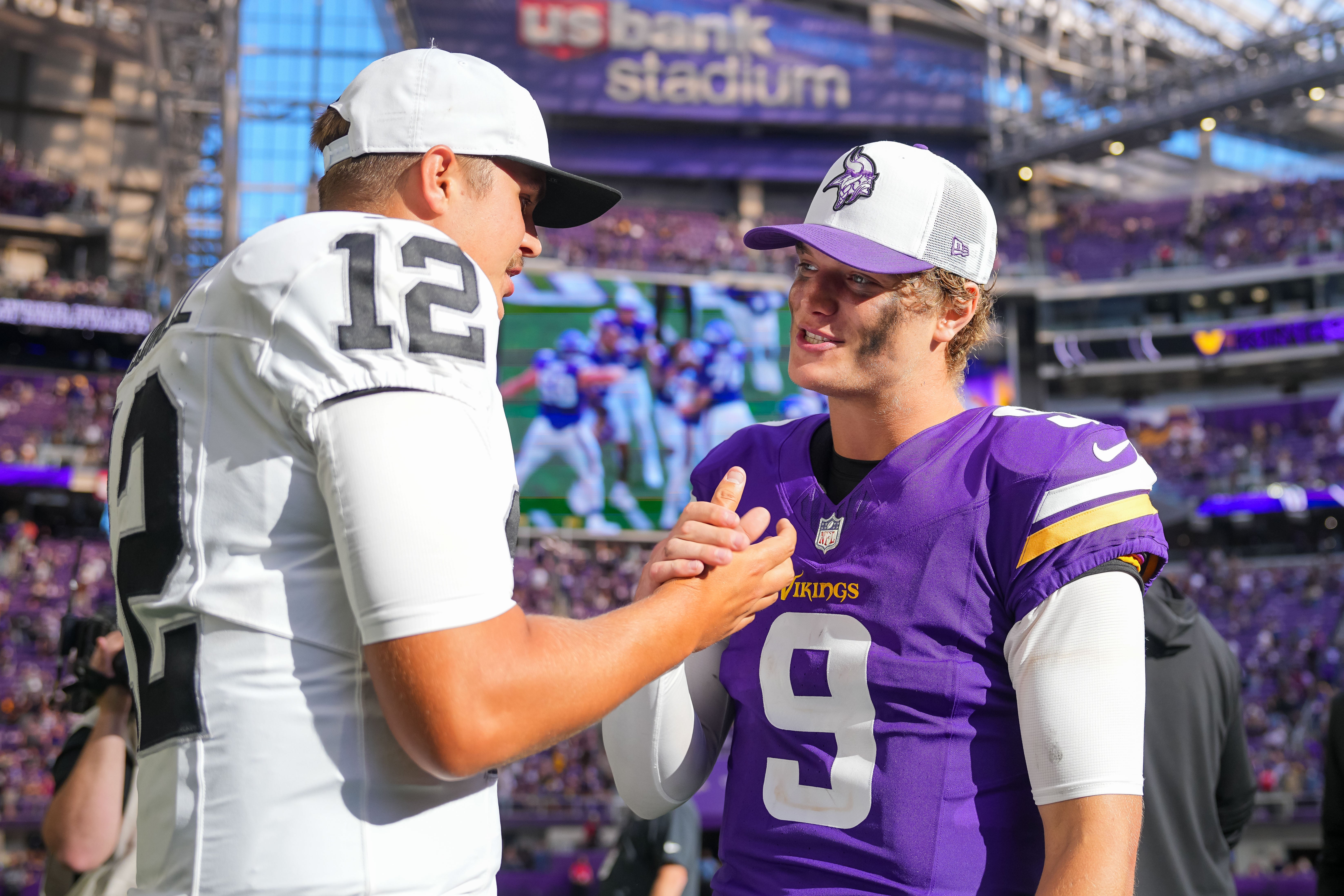 Aug 10, 2024; Minneapolis, Minnesota, USA; Minnesota Vikings quarterback J.J. McCarthy (9) and Las Vegas Raiders quarterback Aidan O'Connell (12) talk after the game at U.S. Bank Stadium.