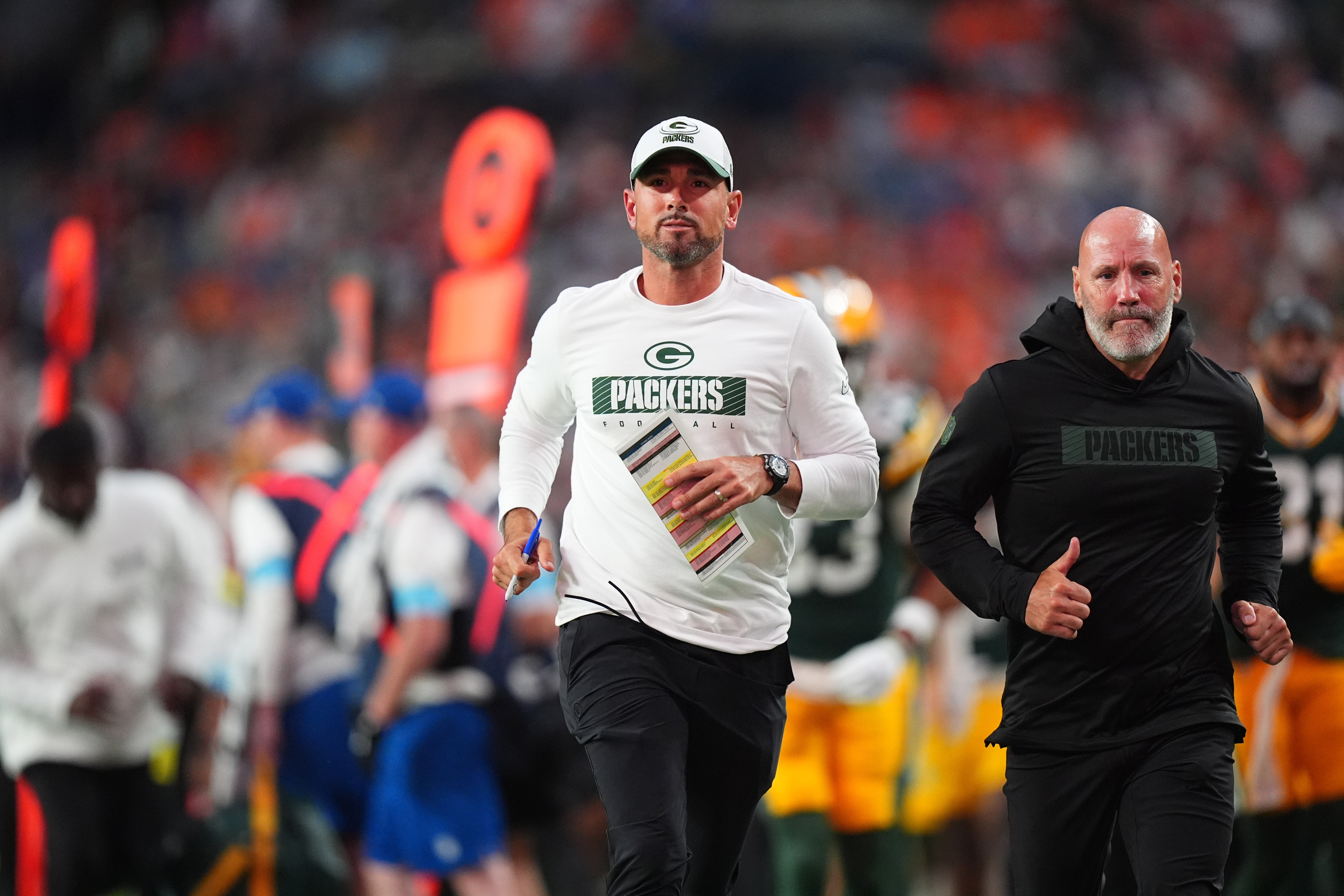 Green Bay Packers head coach Matt LaFleur leaves the field in the first half against the Denver Broncos at Empower Field at Mile High.