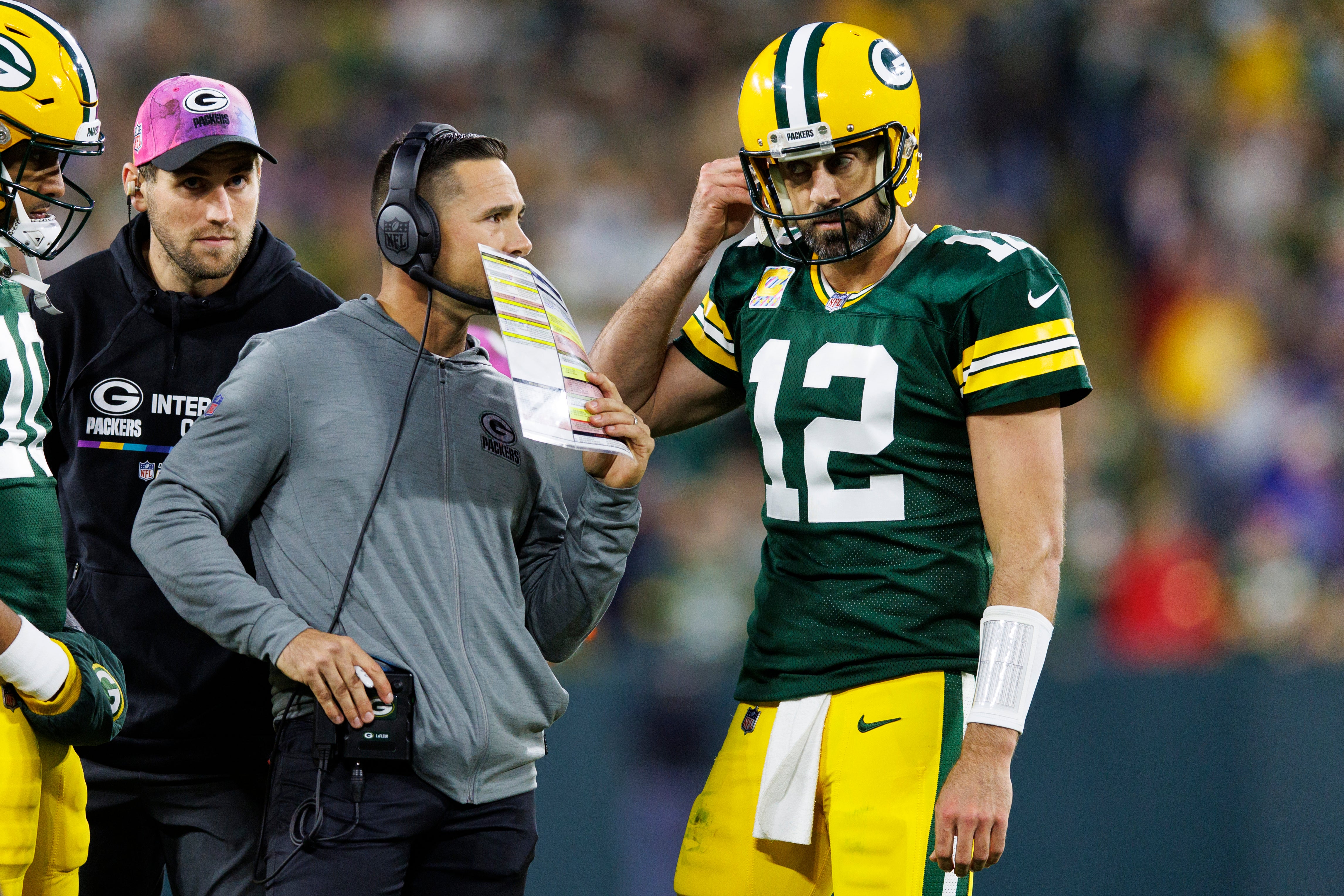 Green Bay Packers head coach Matt LaFleur talks with quarterback Aaron Rodgers (12) during overtime against the New England Patriots at Lambeau Field.