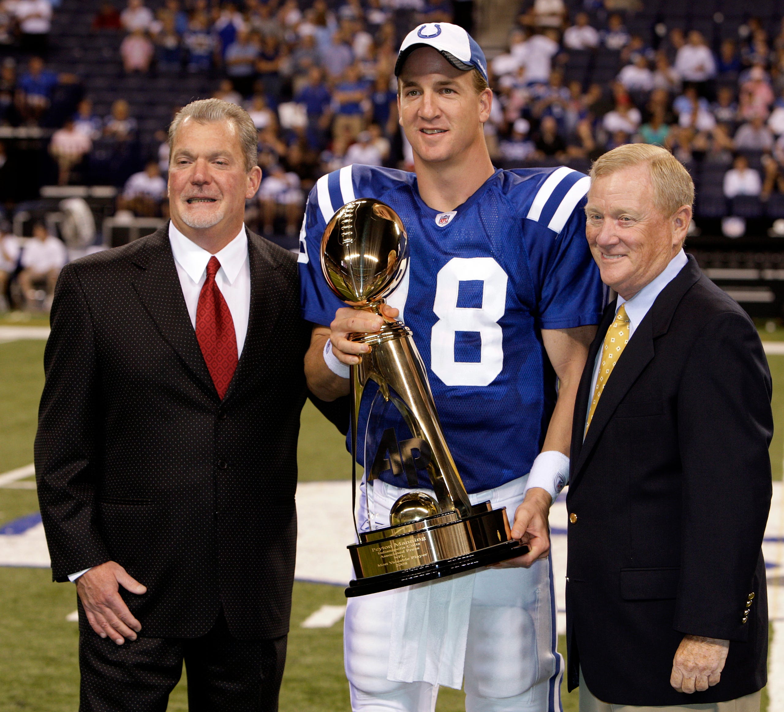Colts owner Jim Irsay, left, and Colts President Bill Polian, right, congratulates Indianapolis Colts' Peyton Manning on winning the 2008 NFL MVP during a halftime ceremony. The Indianapolis Colts