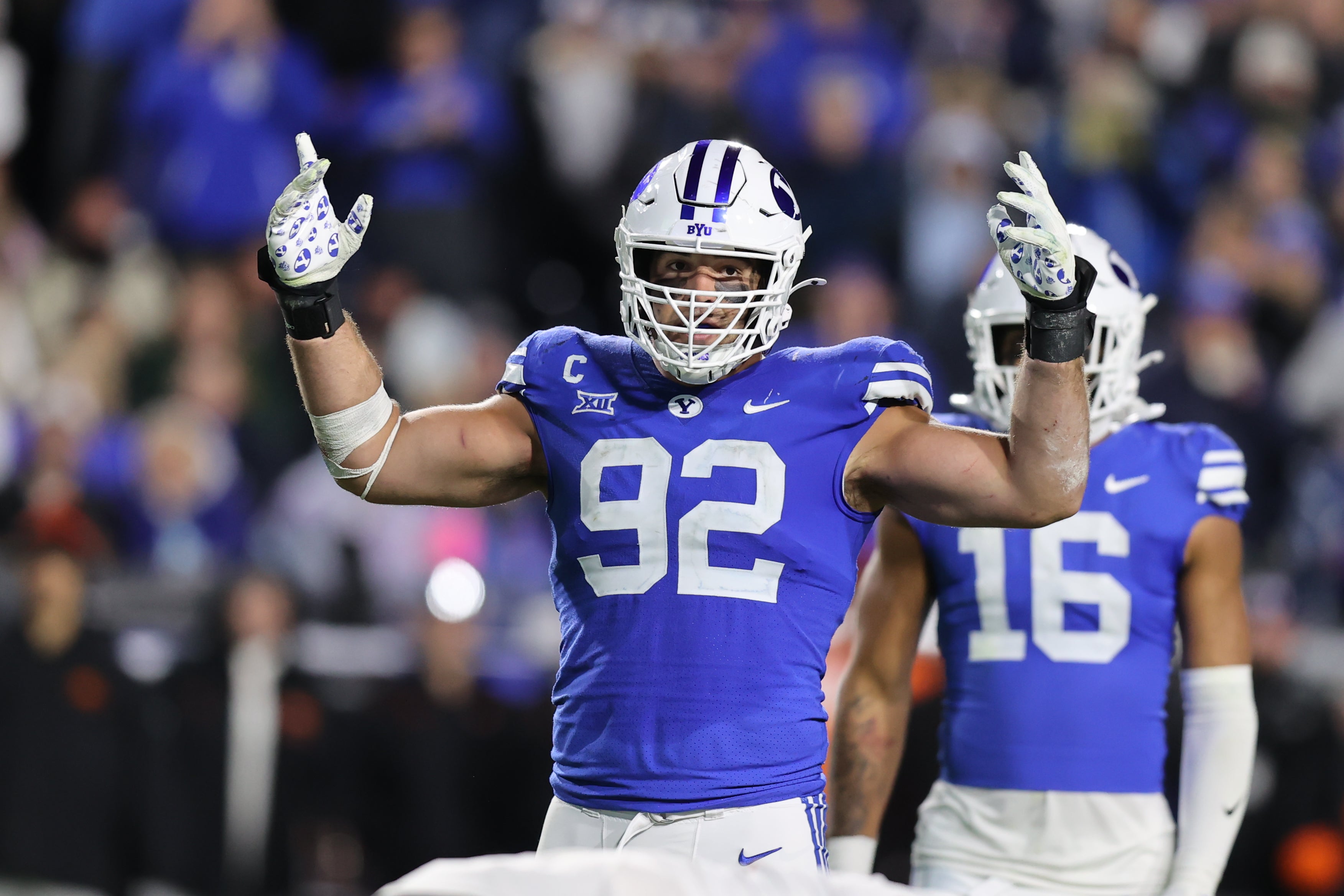 Oct 18, 2024; Provo, Utah, USA; Brigham Young Cougars defensive end Tyler Batty (92) encourages fans to cheer against the Oklahoma State Cowboys during the fourth quarter at LaVell Edwards Stadium.