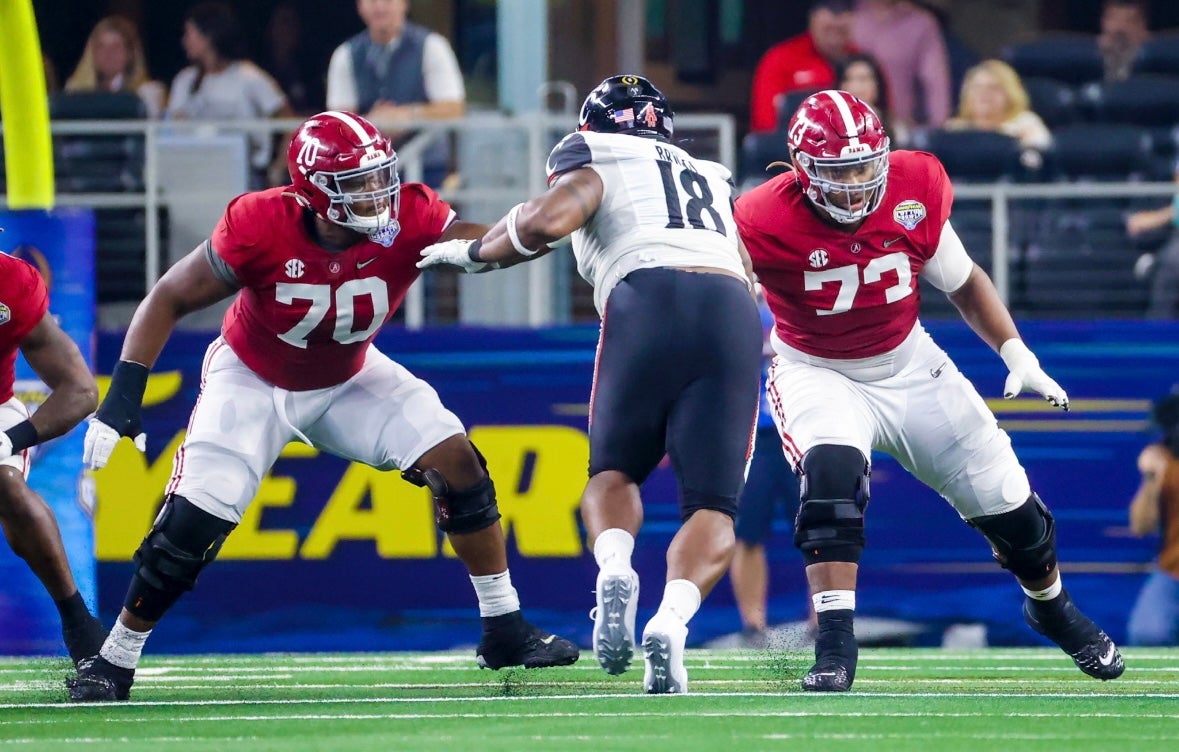 Dec 31, 2021; Arlington, Texas, USA; Alabama Crimson Tide offensive lineman Javion Cohen (70) and offensive lineman Evan Neal (73) block Cincinnati Bearcats defensive lineman Jowon Briggs (18) in the 2021 Cotton Bowl college football CFP national semifinal game at AT&T Stadium. Mandatory Credit: Kevin Jairaj-Imagn Images