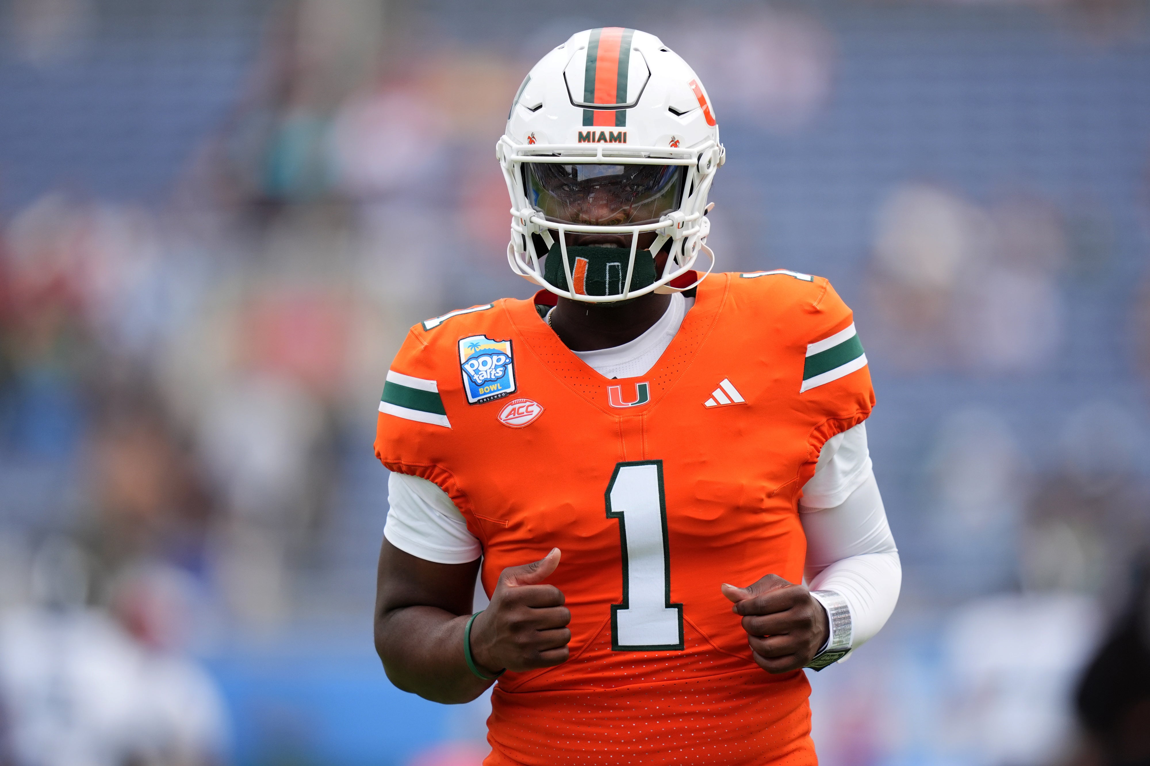 Dec 28, 2024; Orlando, FL, USA; Miami Hurricanes quarterback Cam Ward (1) warms up prior to the game against the Iowa State Cyclones at Camping World Stadium. Mandatory Credit: Jasen Vinlove-Imagn Images