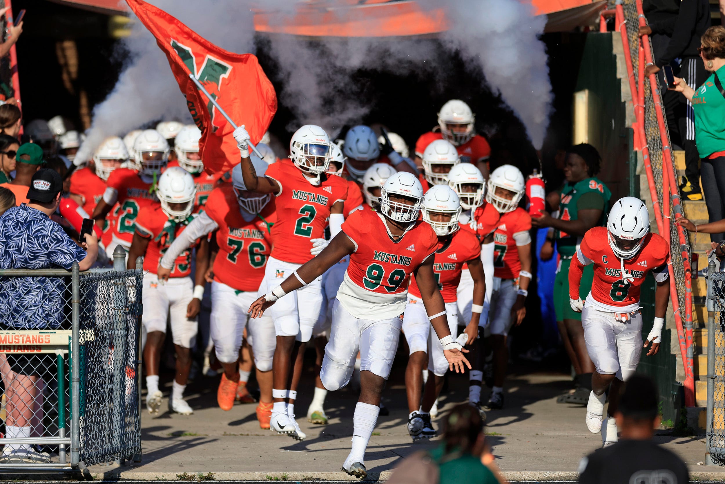 Mandarin's Brian Harris (99) leads the team onto the field before a high school football matchup Thursday, May 23, 2024 at Mandarin High School in Jacksonville, Fla. Mandarin defeated Bolles 35-14.