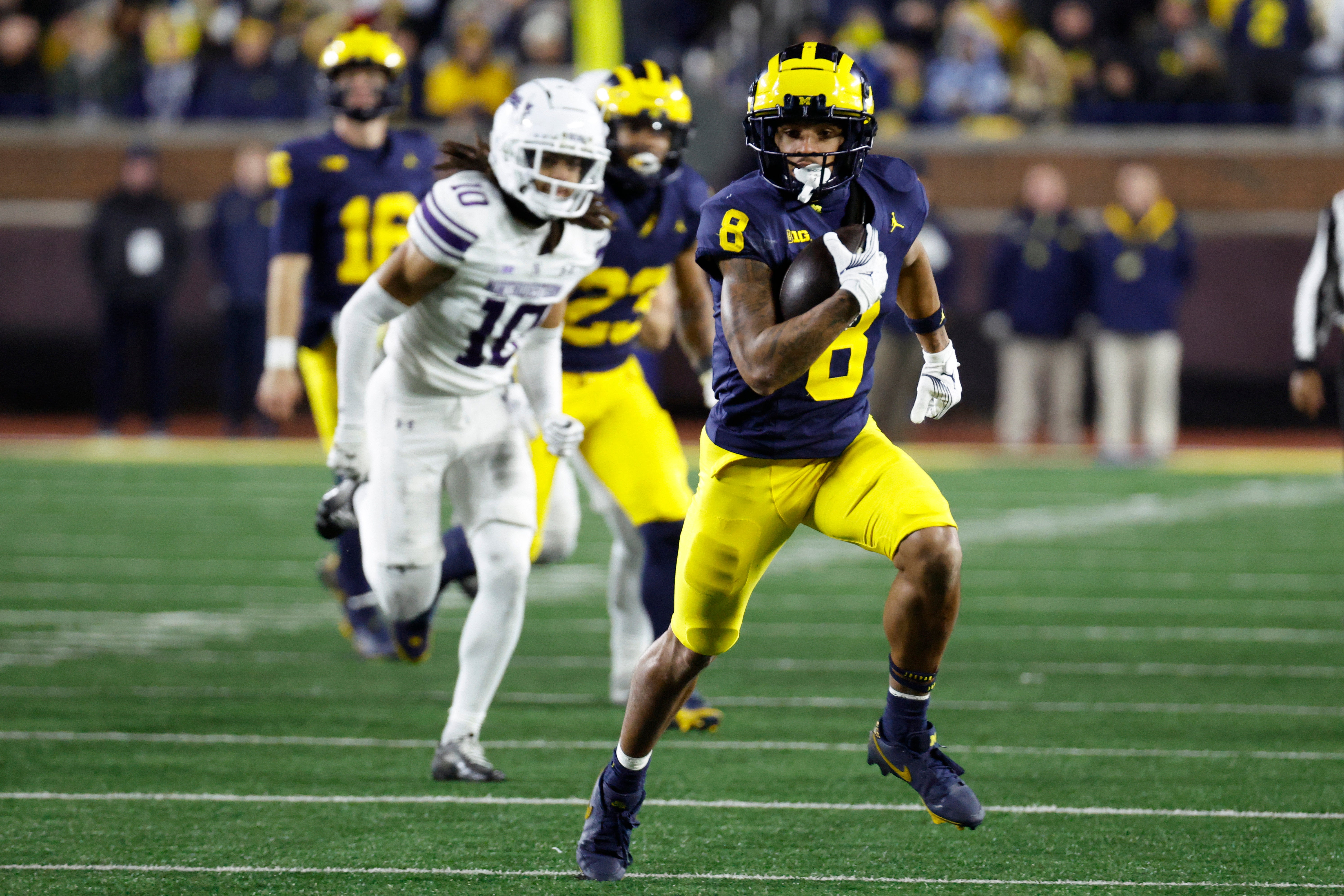 Nov 23, 2024; Ann Arbor, Michigan, USA; Michigan Wolverines wide receiver Tyler Morris (8) runs the ball against the Northwestern Wildcats in the second half at Michigan Stadium.