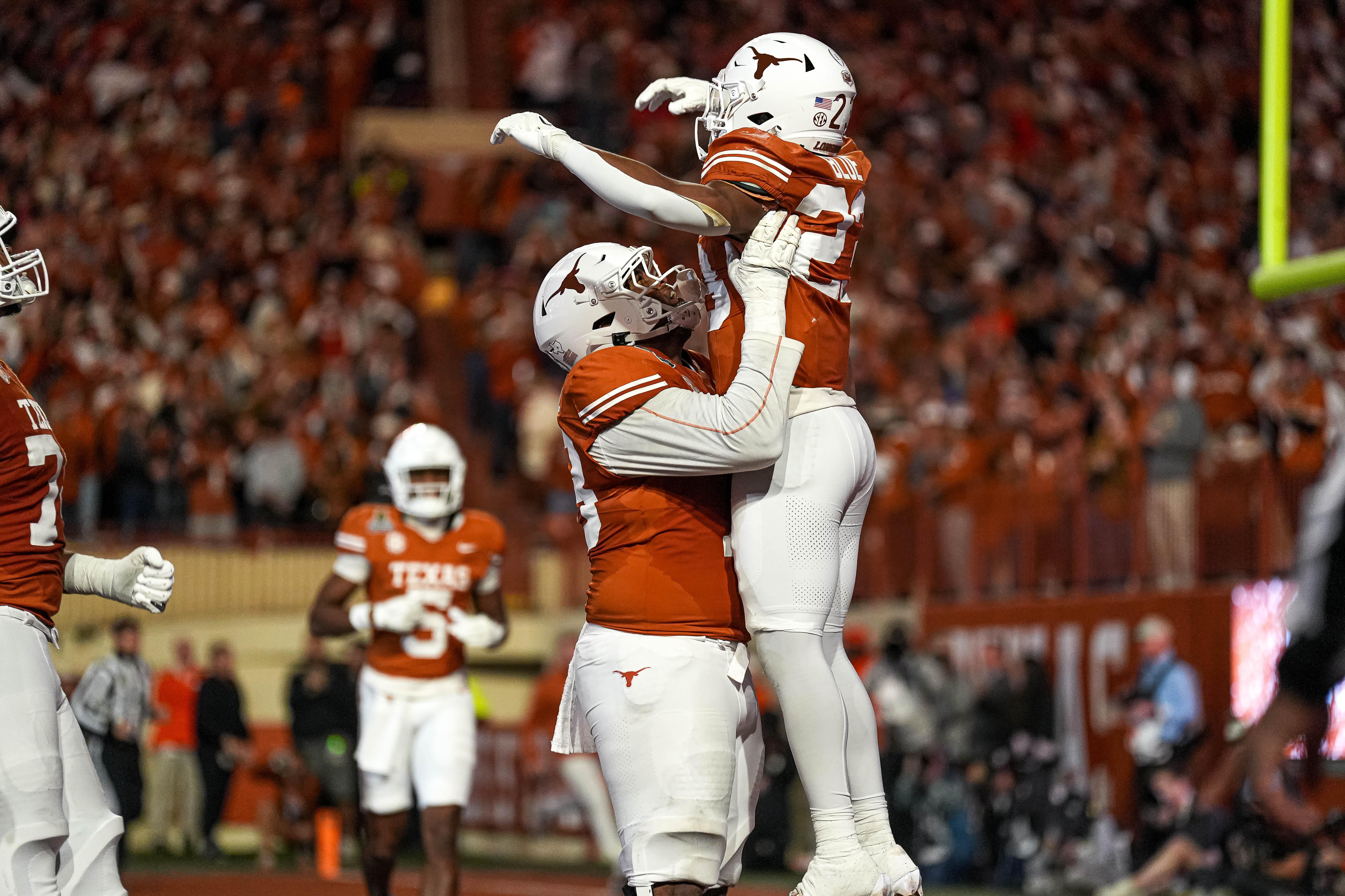 Texas Longhorns offensive lineman Kelvin Banks Jr. (78) celebrates a touchdown by running back JAydon Blue (23) during the game against Clemson in the first round of the College Football Playoffs at Darrell K Royal-Texas Memorial Stadium on Saturday, Dec. 21, 2024.