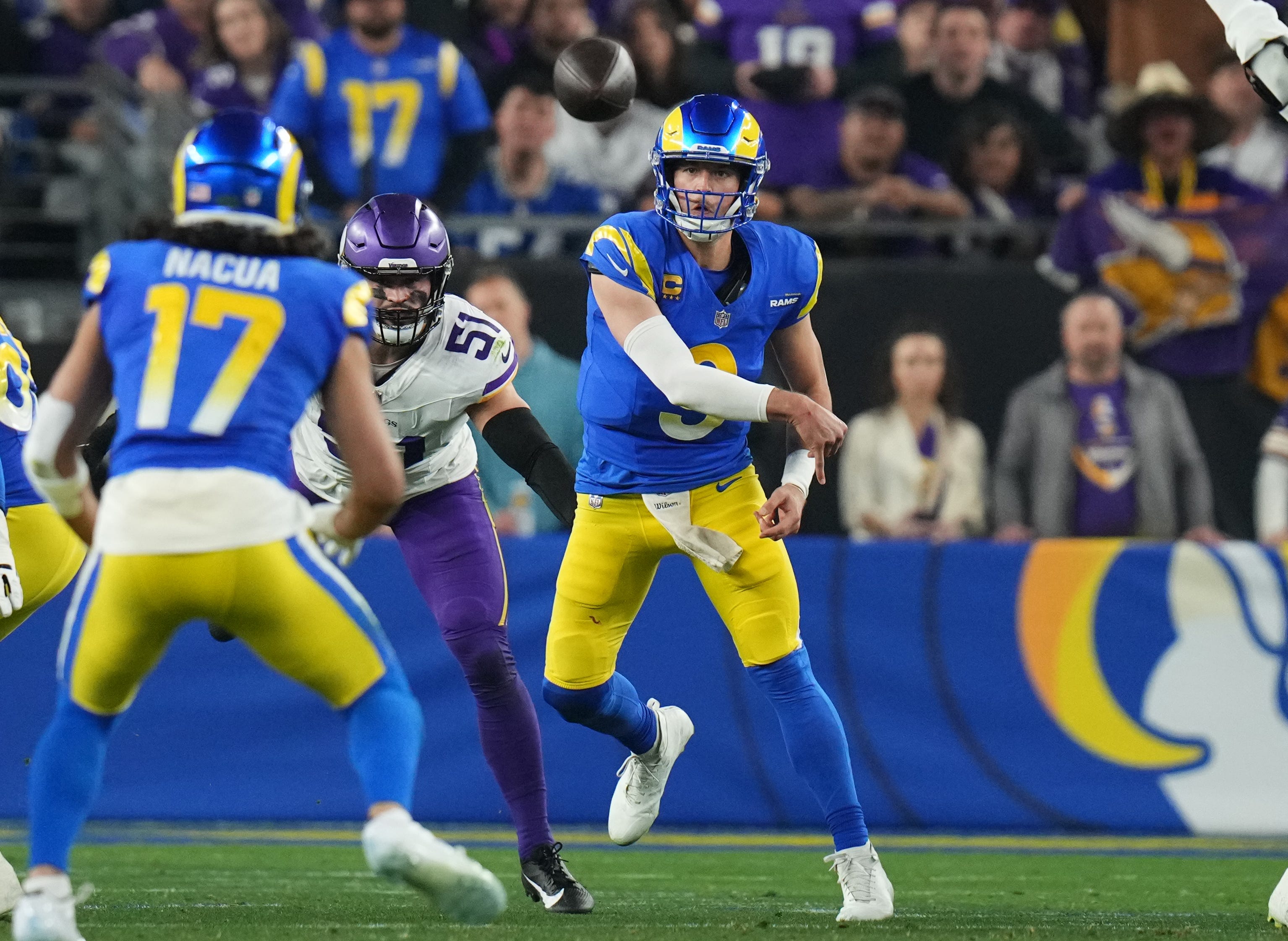 Los Angeles Rams quarterback Matthew Stafford (9) throws the ball to receiver Puka Nacua (17) against the Minnesota Vikings during their playoff game at State Farm Stadium on Jan. 13, 2025, in Glendale.