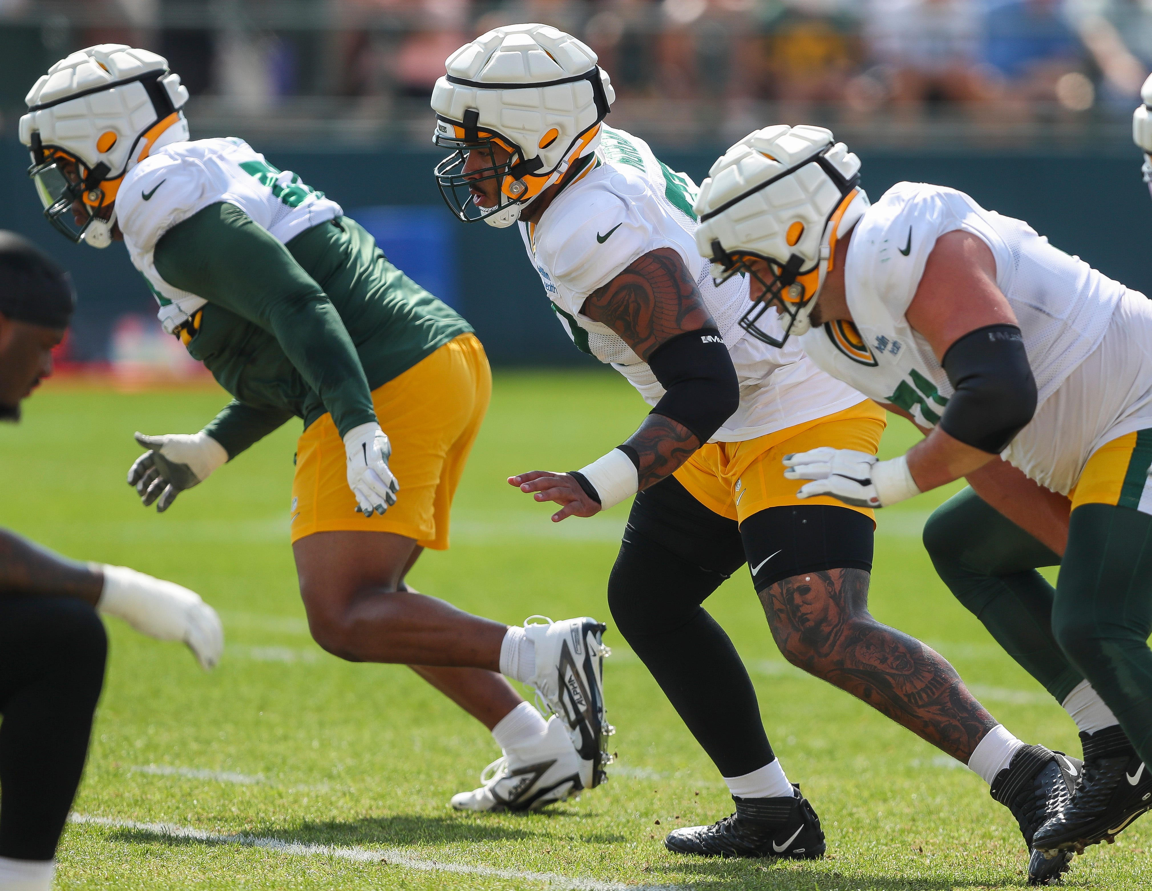 Green Bay Packers offensive lineman Jordan Morgan (77) runs through a drill during practice on Tuesday, August 13, 2024, at Ray Nitschke Field in Ashwaubenon, Wis.