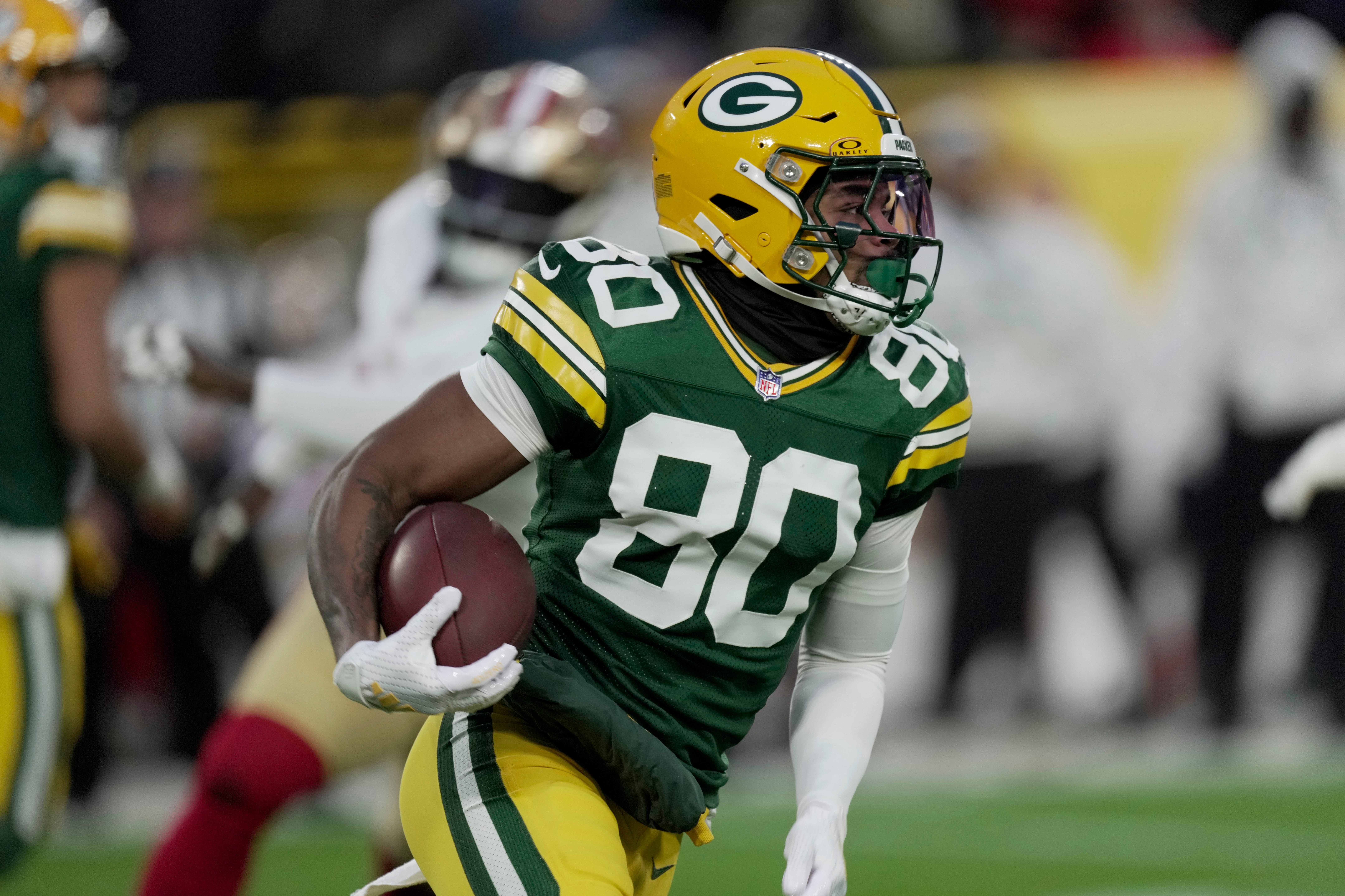 Green Bay Packers wide receiver Bo Melton (80) runs for the five yards during the second quarter of their game against the San Francisco 49ers Sunday, November 24, 2024 at Lambeau Field in Green Bay, Wisconsin.