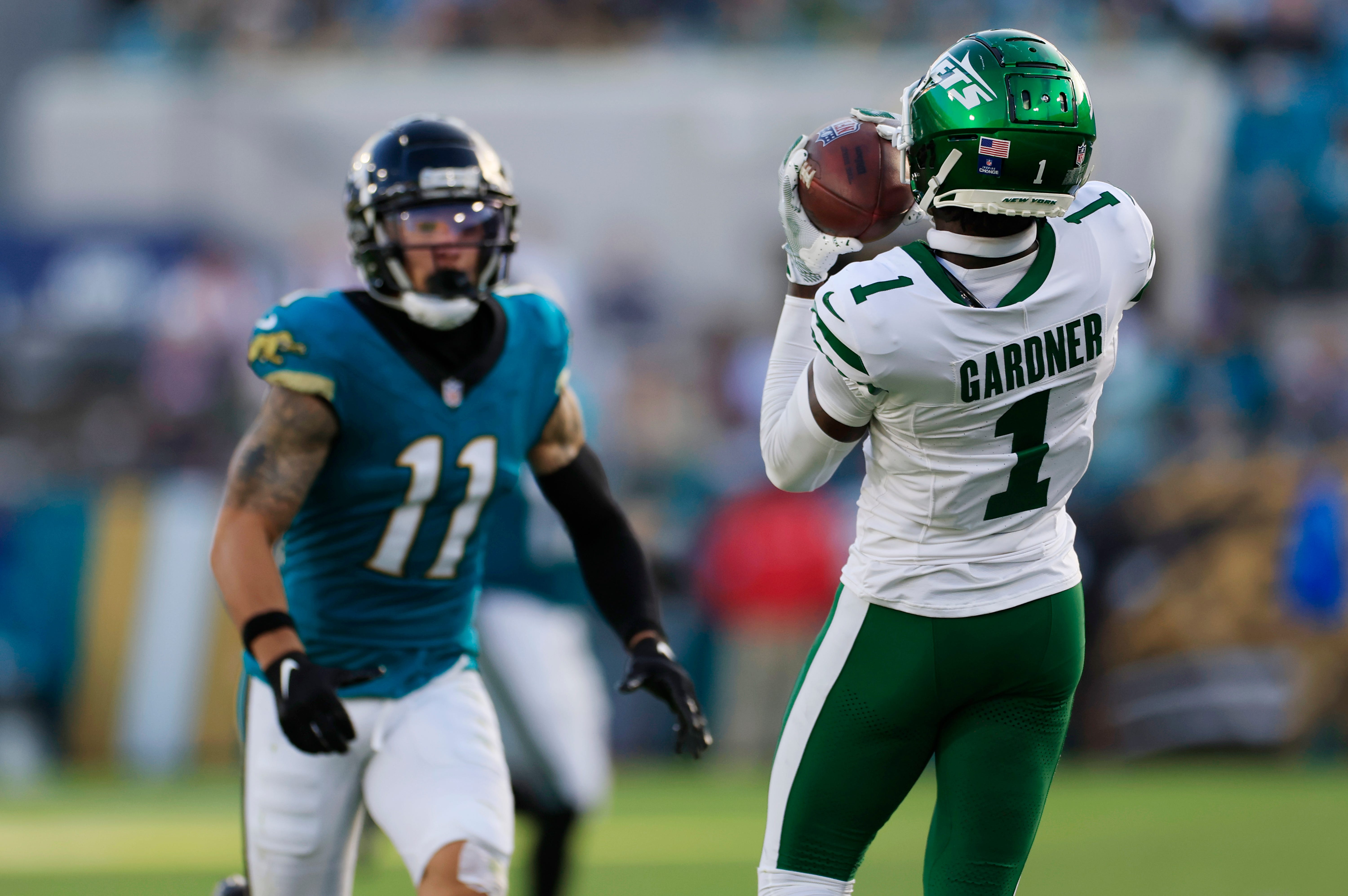 New York Jets cornerback Sauce Gardner (1) hauls in an interception against Jacksonville Jaguars wide receiver Parker Washington (11) during the fourth quarter Sunday, Dec. 15, 2024 at EverBank Stadium in Jacksonville, Fla. The Jets held off the Jaguars 32-25.