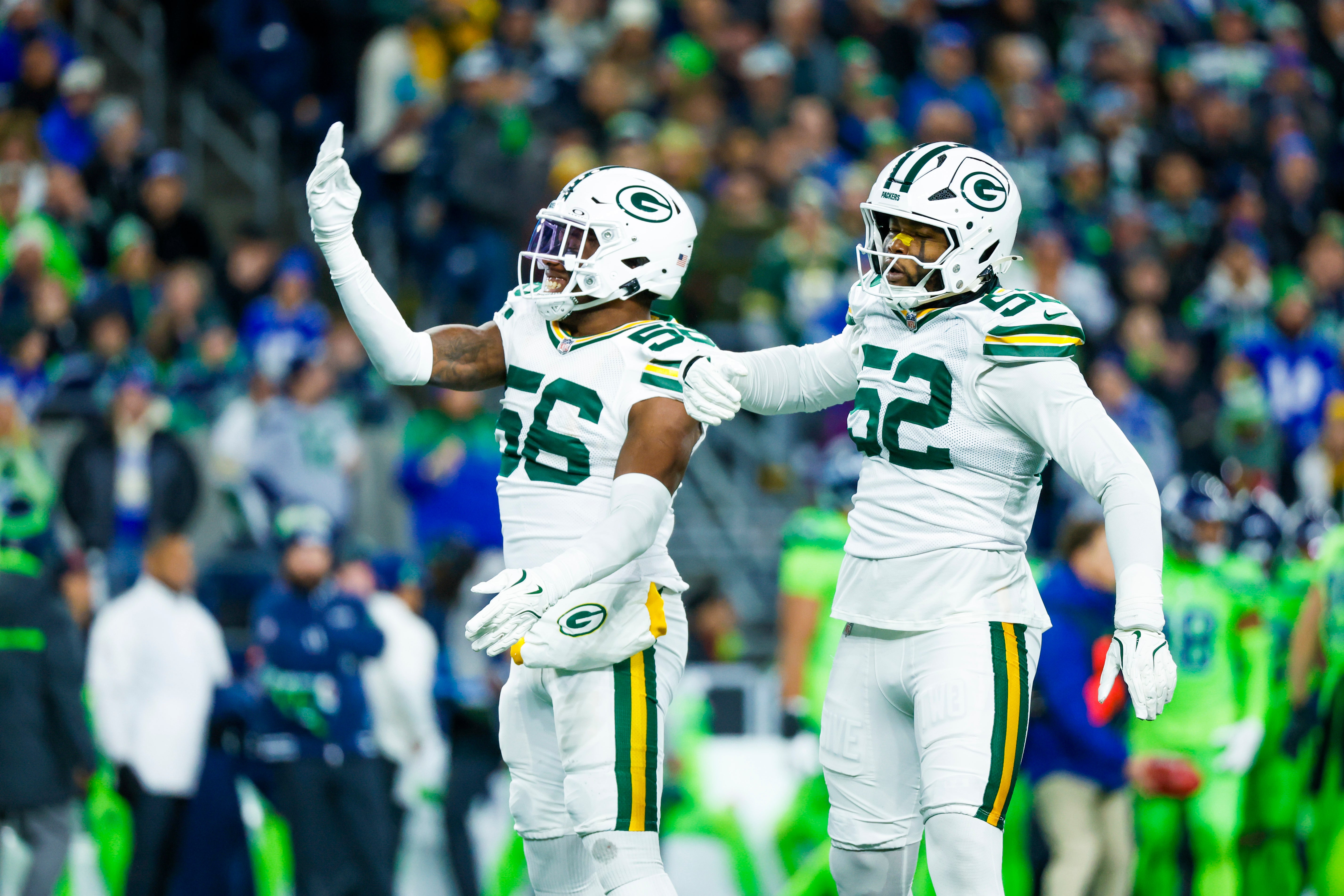 Green Bay Packers linebacker Edgerrin Cooper (56) celebrates with defensive end Rashan Gary (52) following a sack against the Seattle Seahawks during the first quarter at Lumen Field.