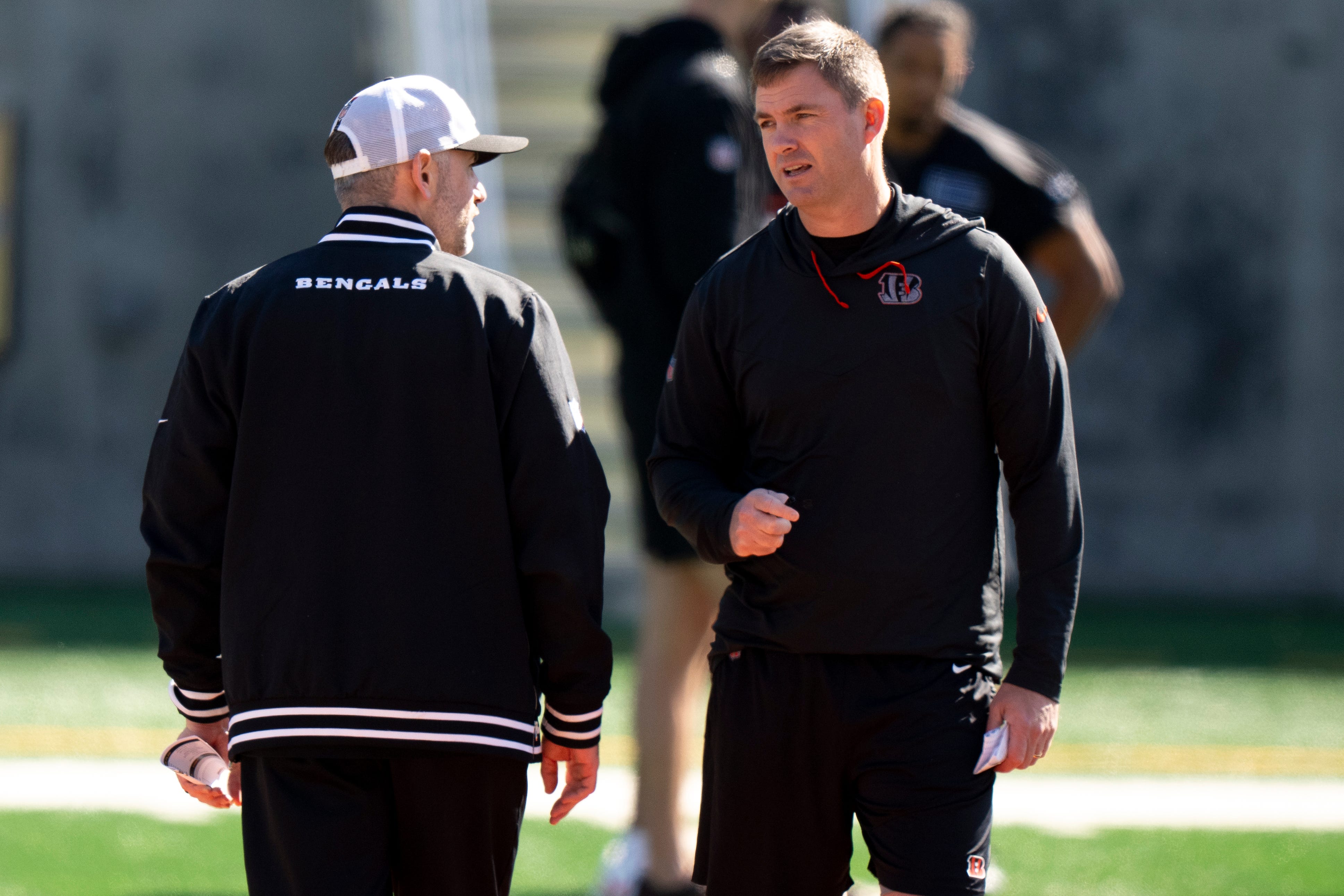 Bengals head coach Zac Taylor speaks to Bengals offensive coordinator Dan Pitcher during the Bengals Rookie Mini Camp on Friday, May 9, 2025 at Paycor Stadium in Cincinnati.