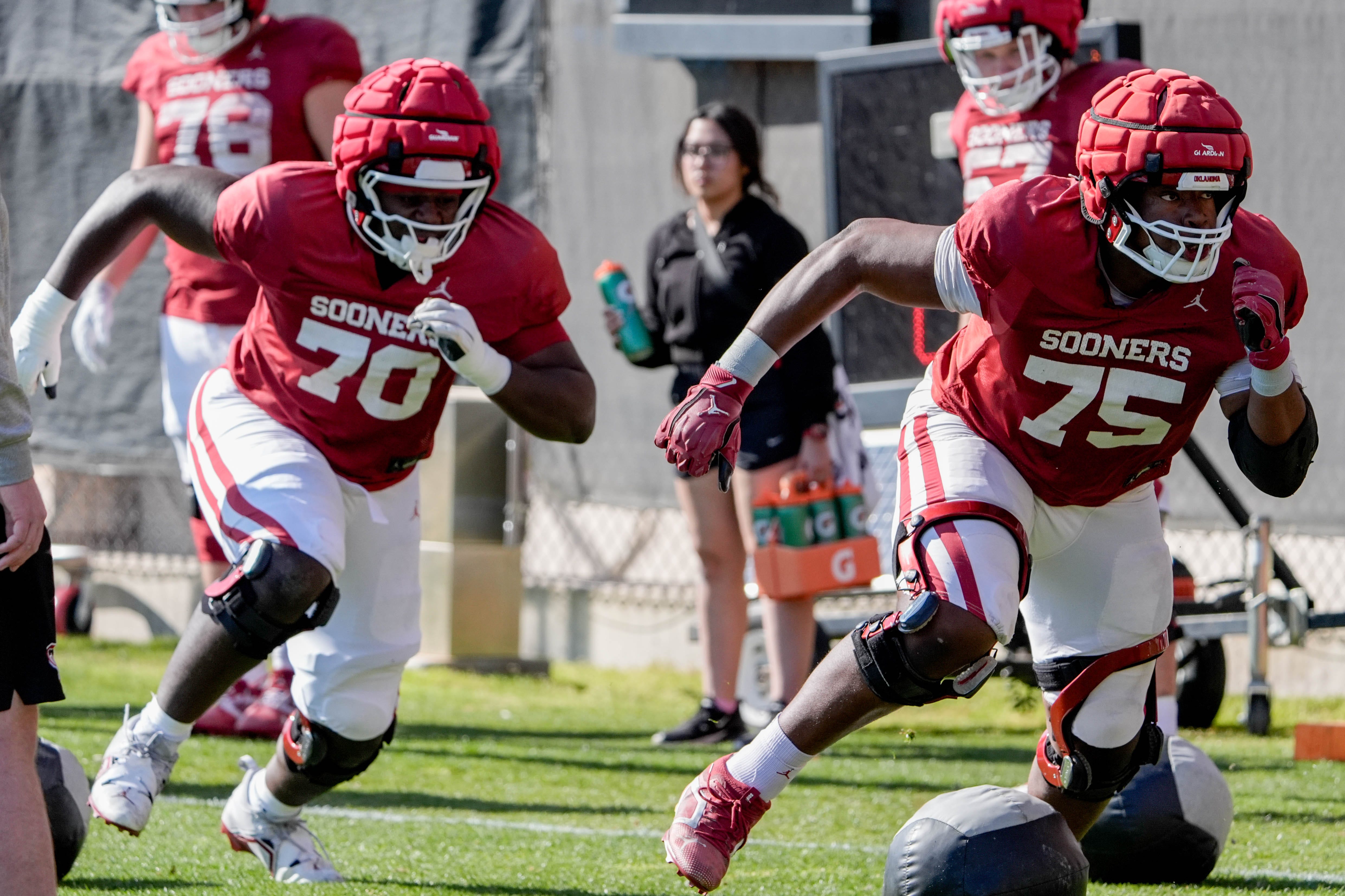 Ryan Fodje (70) and Daniel Akinkunmi (75) runs drills during an Oklahoma (OU) football practice at the Gaylord Family Oklahoma Memorial Stadium in Norman, Okla., on Tuesday, March 25, 2025.
