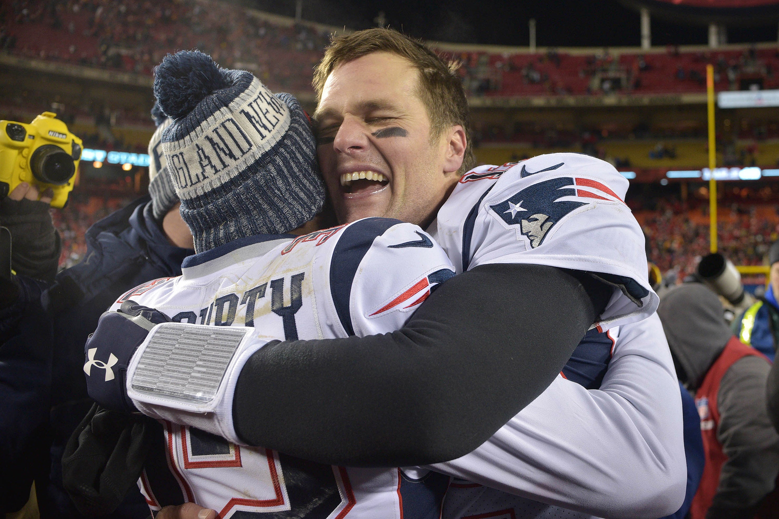 Jan 20, 2019; Kansas City, MO, USA; New England Patriots quarterback Tom Brady (12) celebrates with Patriots free safety Devin McCourty (32) after defeating the Kansas City Chiefs during overtime in the AFC Championship game at Arrowhead Stadium.