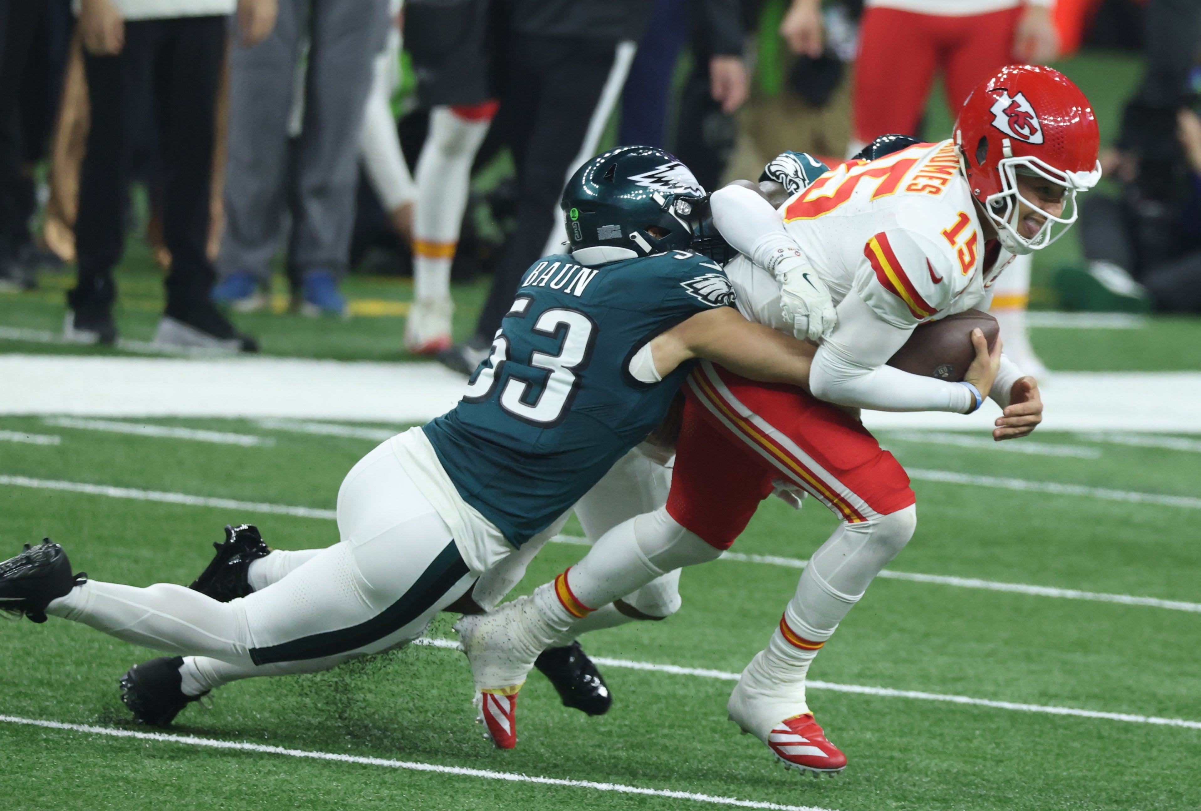 Kansas City Chiefs quarterback Patrick Mahomes (15) is tackled by Philadelphia Eagles linebacker Zack Baun (53) in Super Bowl LIX between the Philadelphia Eagles and the Kansas City Chiefs at Ceasars.