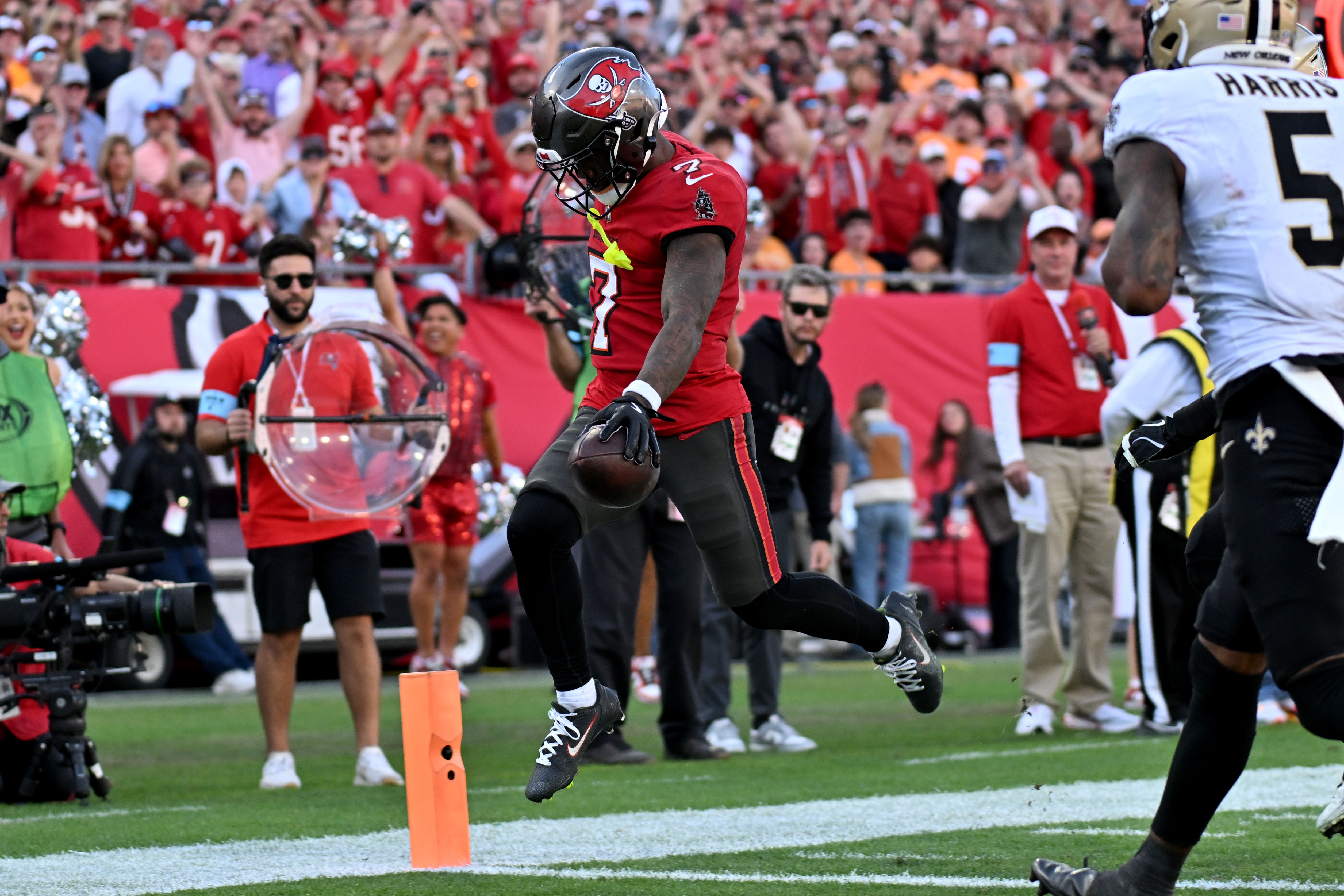Jan 5, 2025; Tampa, Florida, USA; Tampa Bay Buccaneers running back Bucky Irving (7) scores a touchdown in the second half against the New Orleans Saints at Raymond James Stadium.