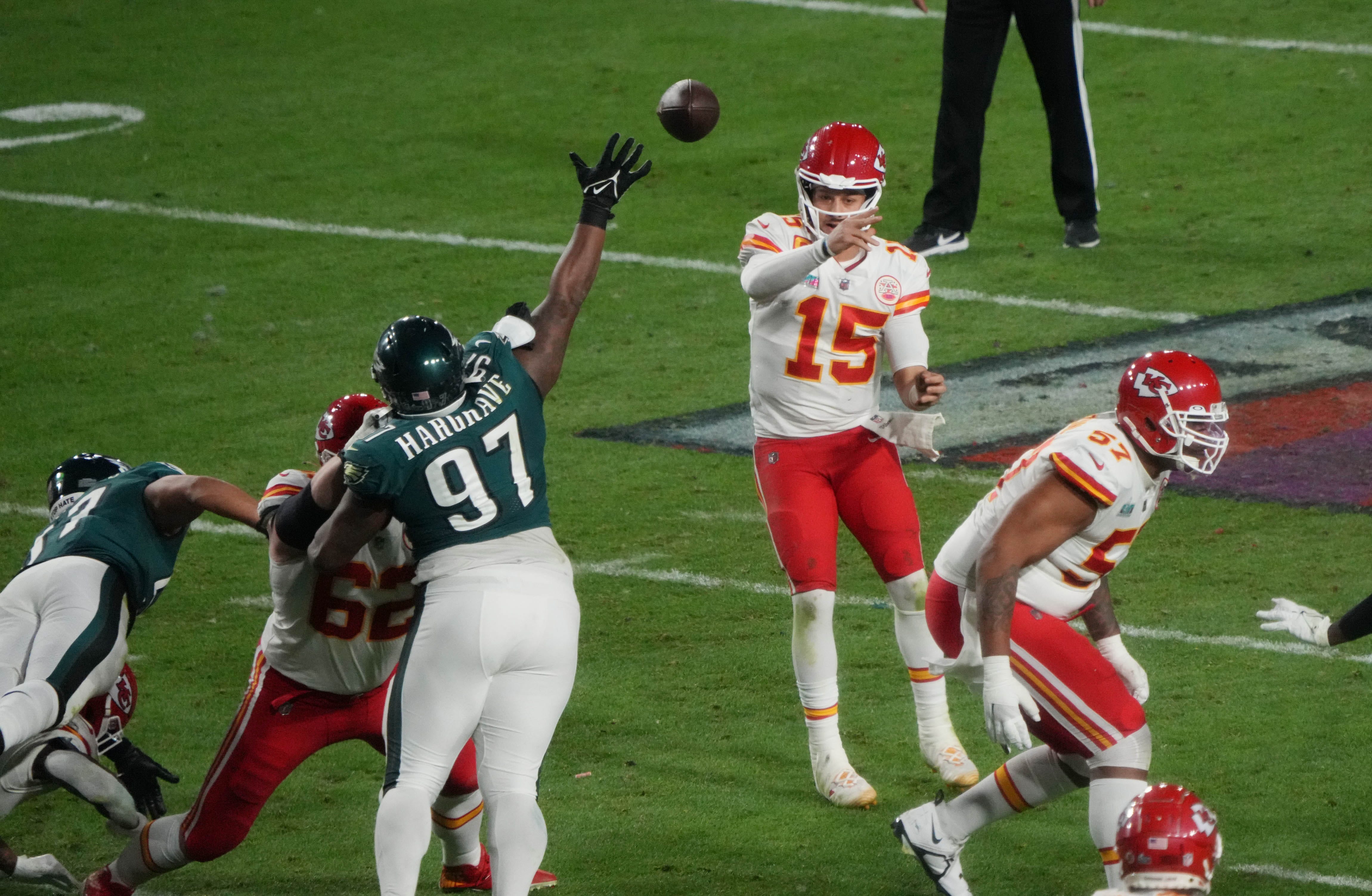Chiefs quarterback Patrick Mahomes looks for an opening in the defense as Eagles lineman Javon Hargrave gets in his face during Super Bowl 57.