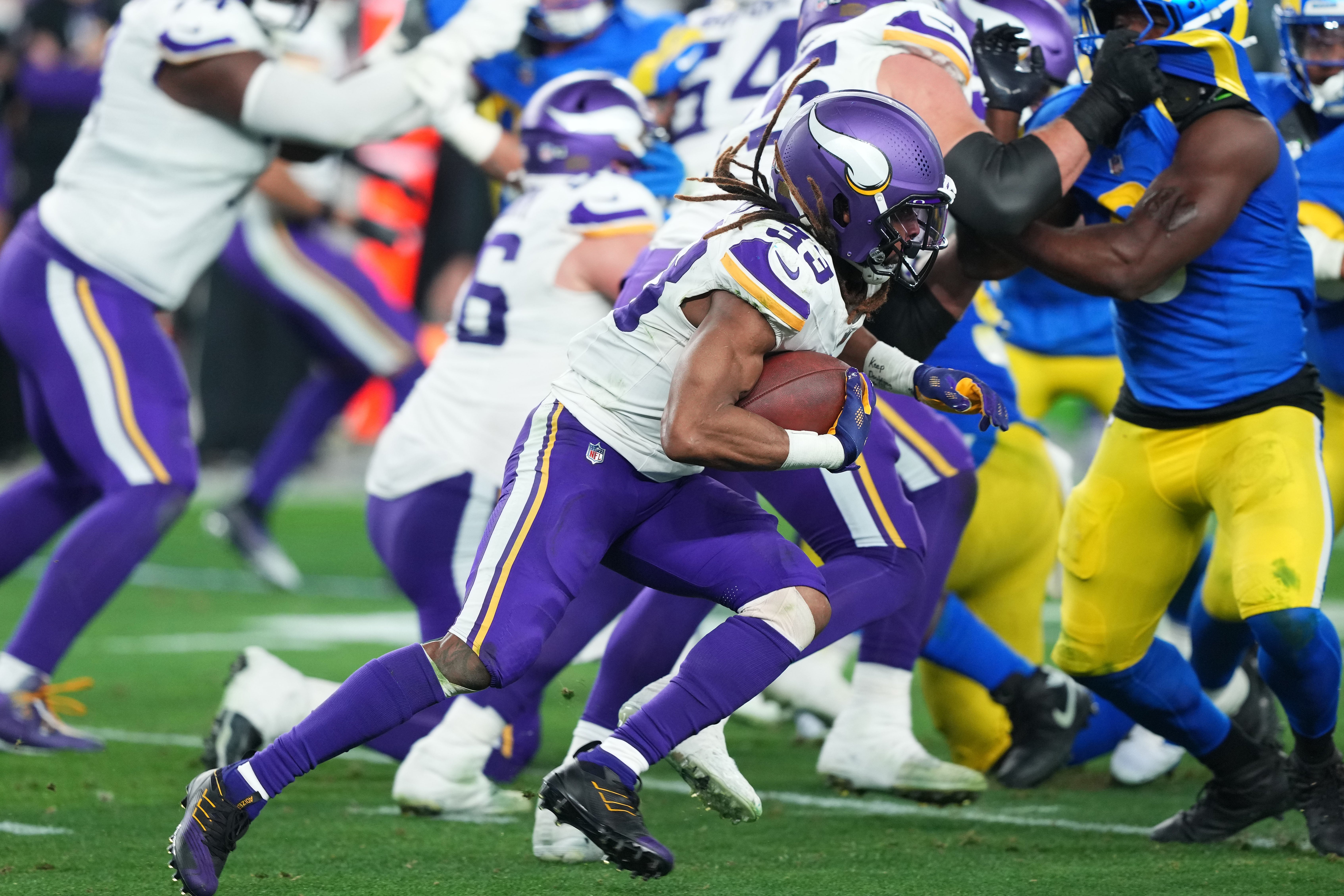 Jan 13, 2025; Glendale, AZ, USA; Minnesota Vikings running back Aaron Jones (33) rushes the ball against the Los Angeles Rams during the second half in an NFC wild card game at State Farm Stadium.