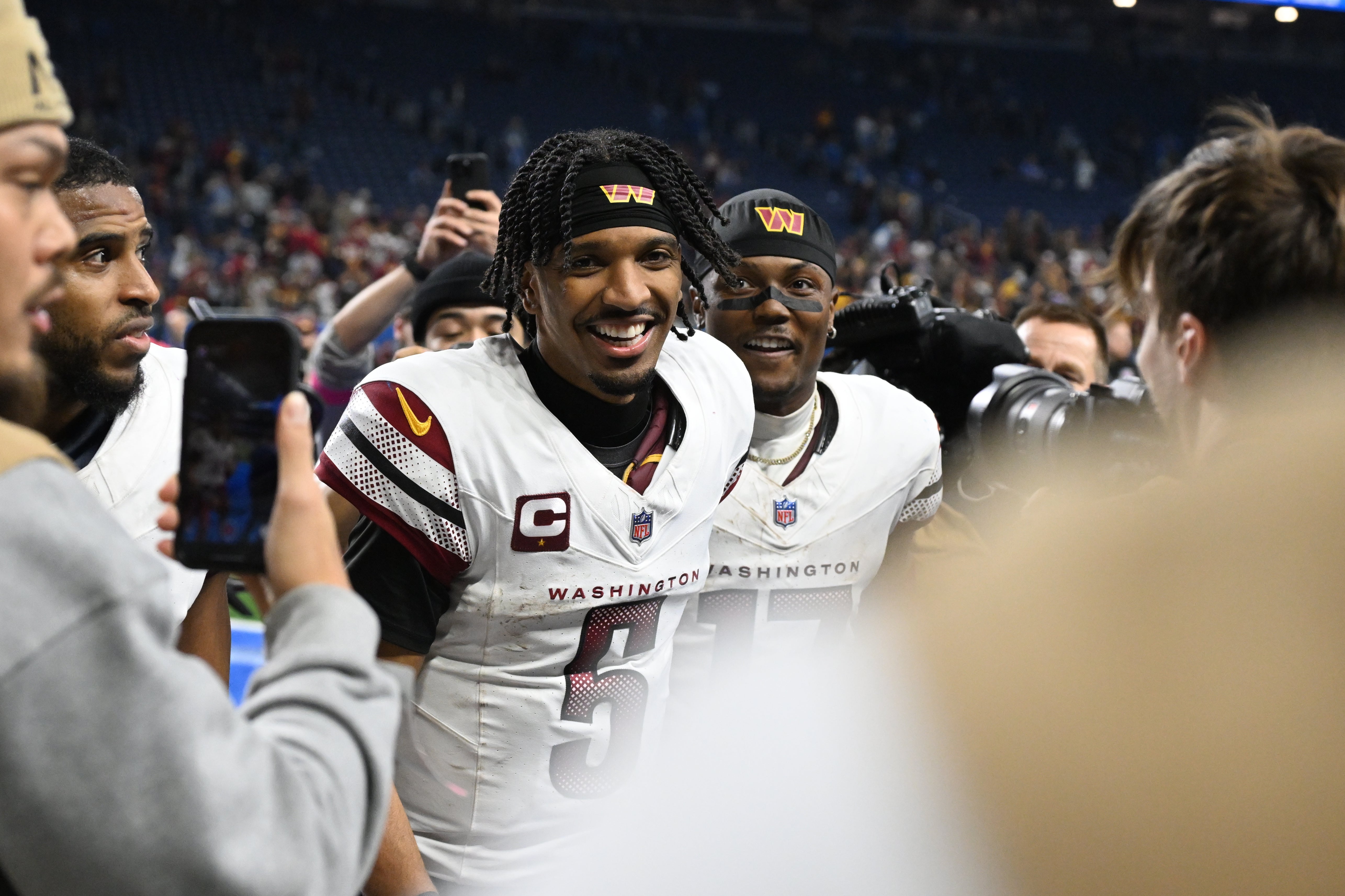 Jan 18, 2025; Detroit, Michigan, USA; Washington Commanders quarterback Jayden Daniels (5) and wide receiver Terry McLaurin (17) celebrate the win against Detroit Lions in a 2025 NFC divisional round game at Ford Field.