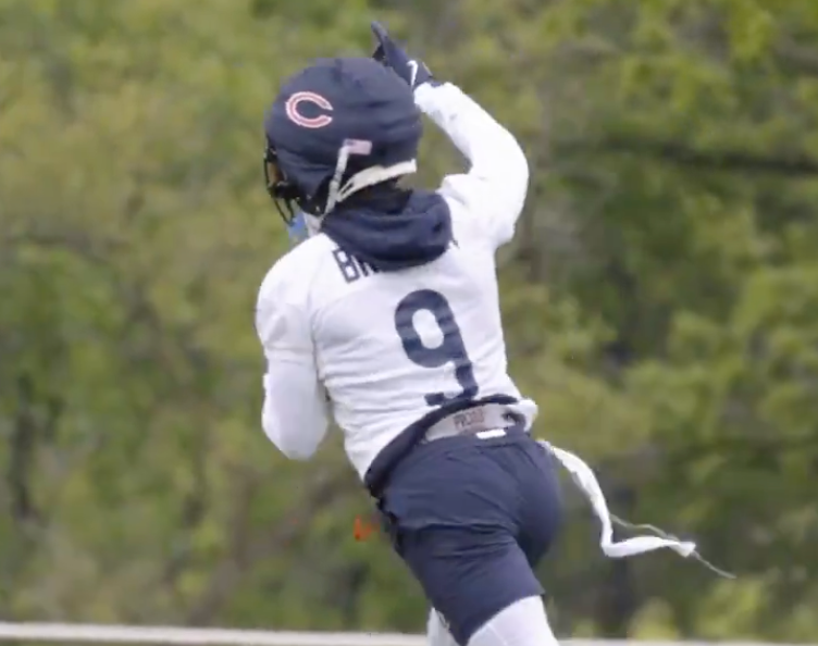 Jaquan Brisker runs after recording an interception during OTAs.
