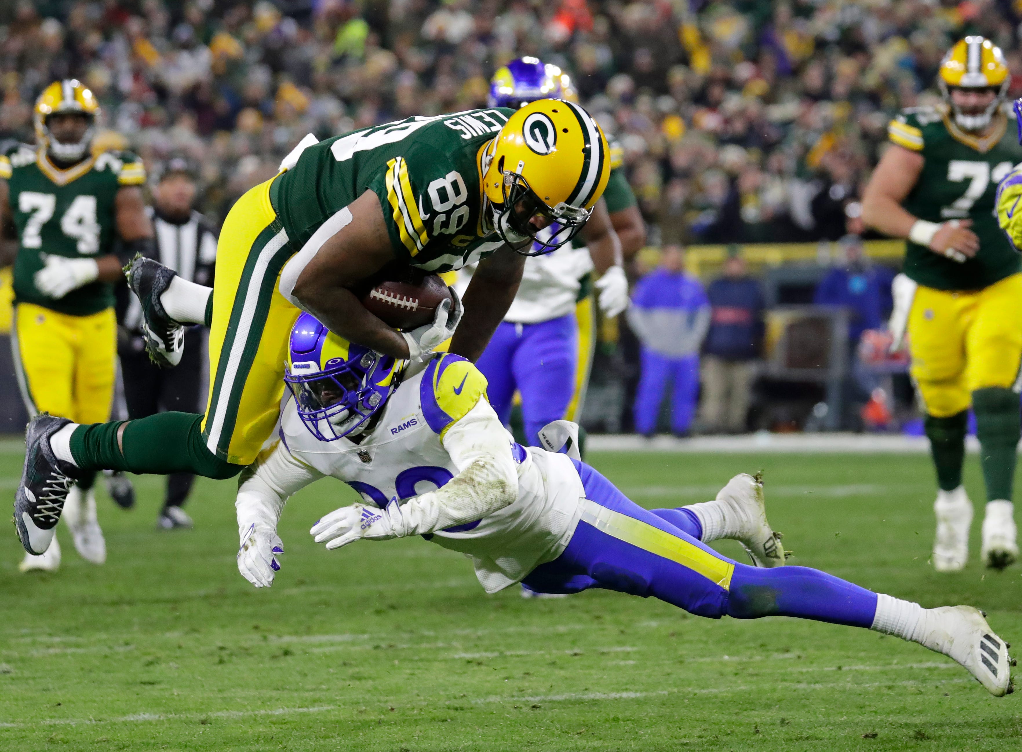 Green Bay Packers tight end Marcedes Lewis (89) dives for a first down on a reception against Los Angeles Rams safety Nick Scott (33) during their football game Monday, December 19, at Lambeau Field in Green Bay, Wis.