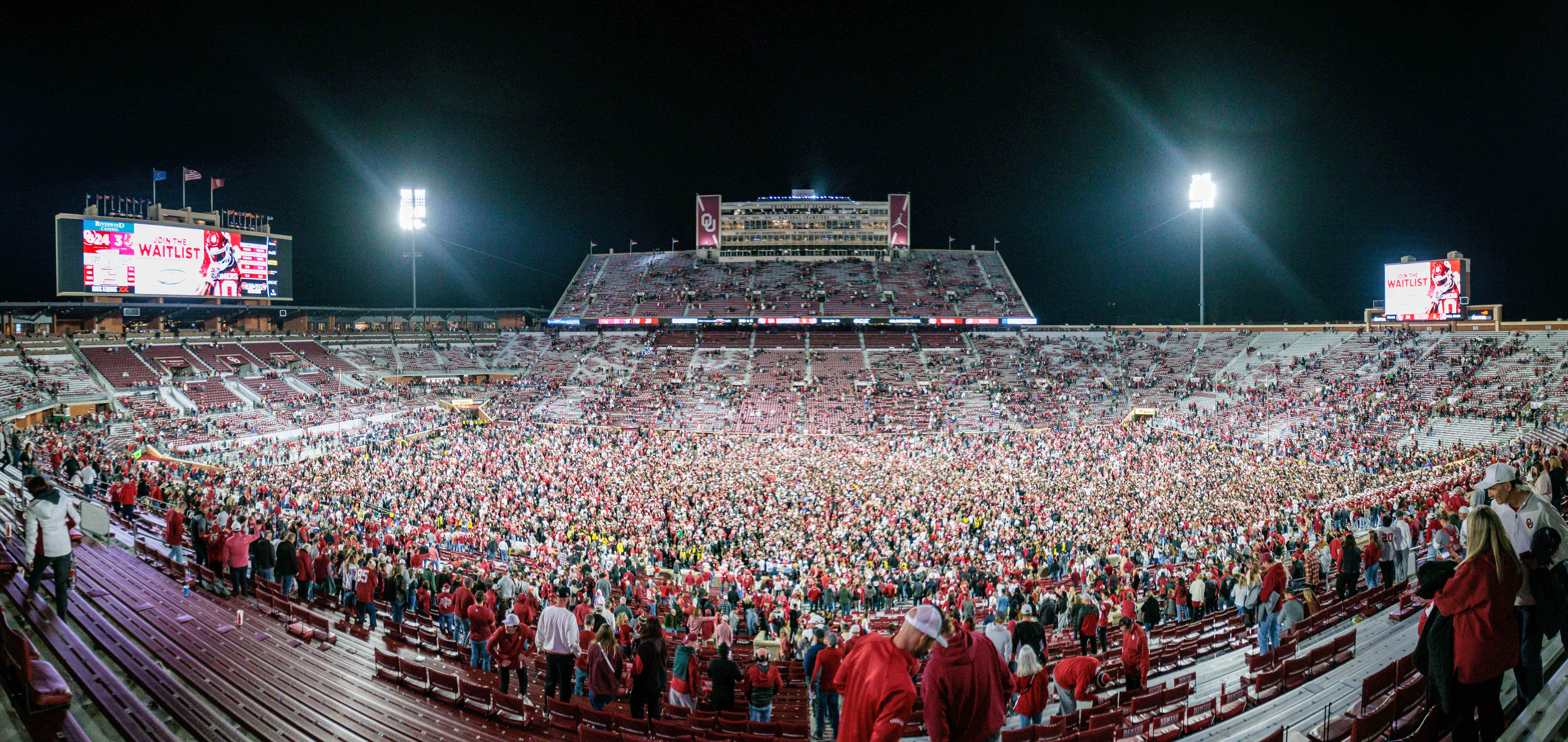 Nov 23, 2024; Norman, Oklahoma, USA; Fans rush the field after the game between the Oklahoma Sooners and the Alabama Crimson Tide at Gaylord Family-Oklahoma Memorial Stadium.