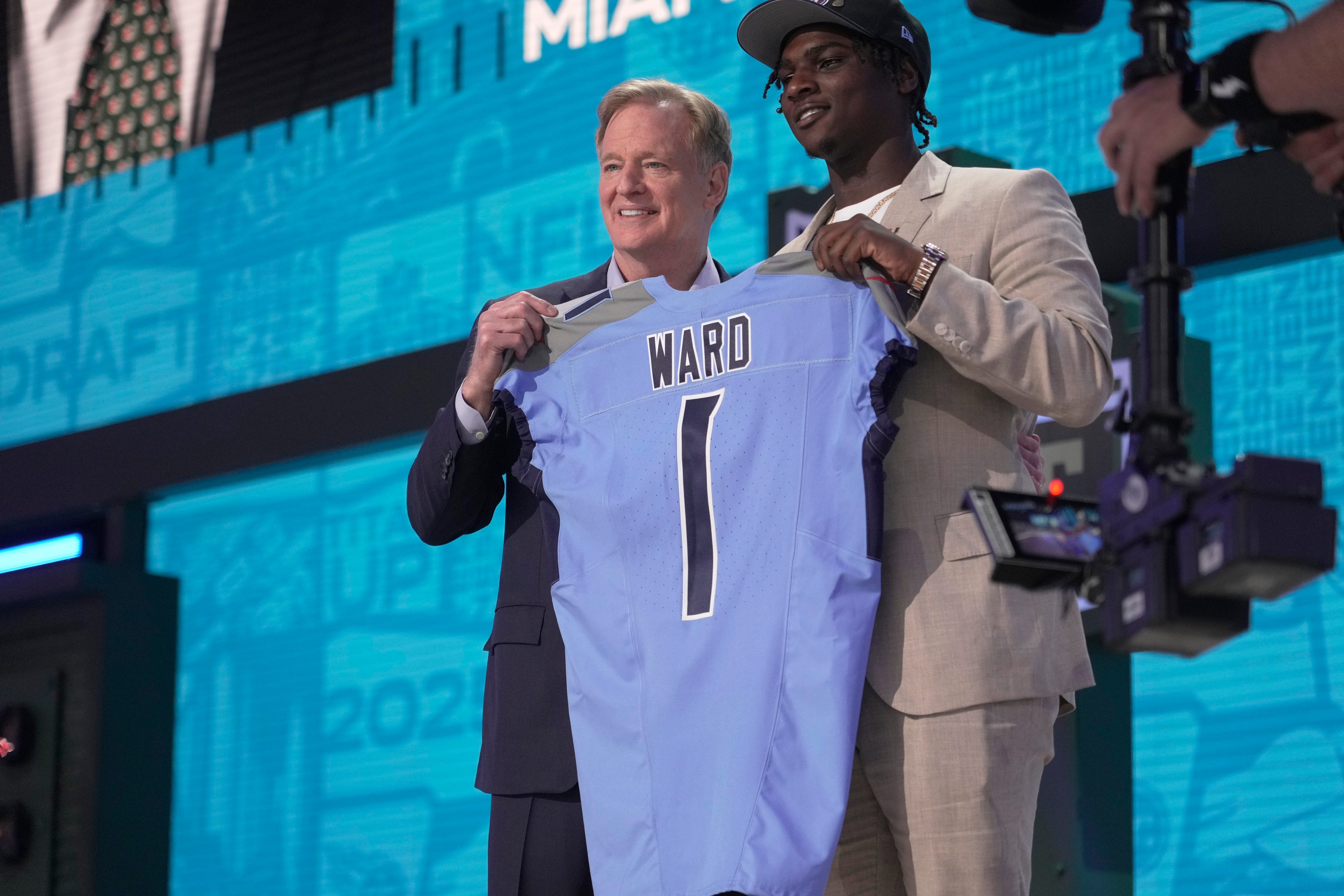Cam Ward, QB, from Miami holds a jersey with NFL Commissioner Roger Goodell after being selected 1st overall by the Tennessee Titans during the first round of the 2025 NFL Draft at Lambeau Field on April 24, 2025 in Green Bay, Wisconsin.