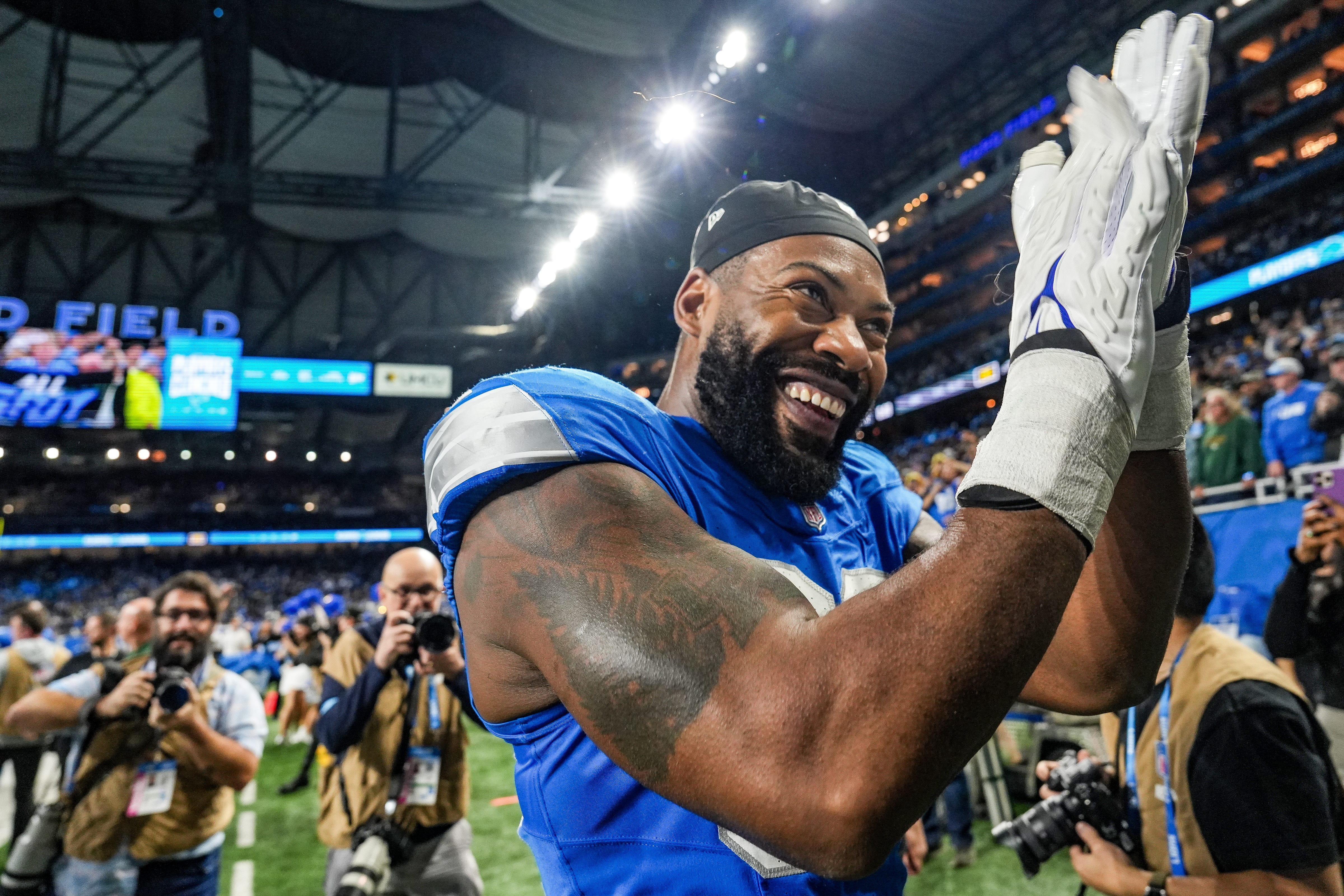 Detroit Lions defensive end Za'Darius Smith (99) claps his hands together after defeating the Green Bay Packers, clinching a spot in the playoffs, during the Thursday Night Football at Ford Field in Detroit on Thursday, Dec. 5, 2024.