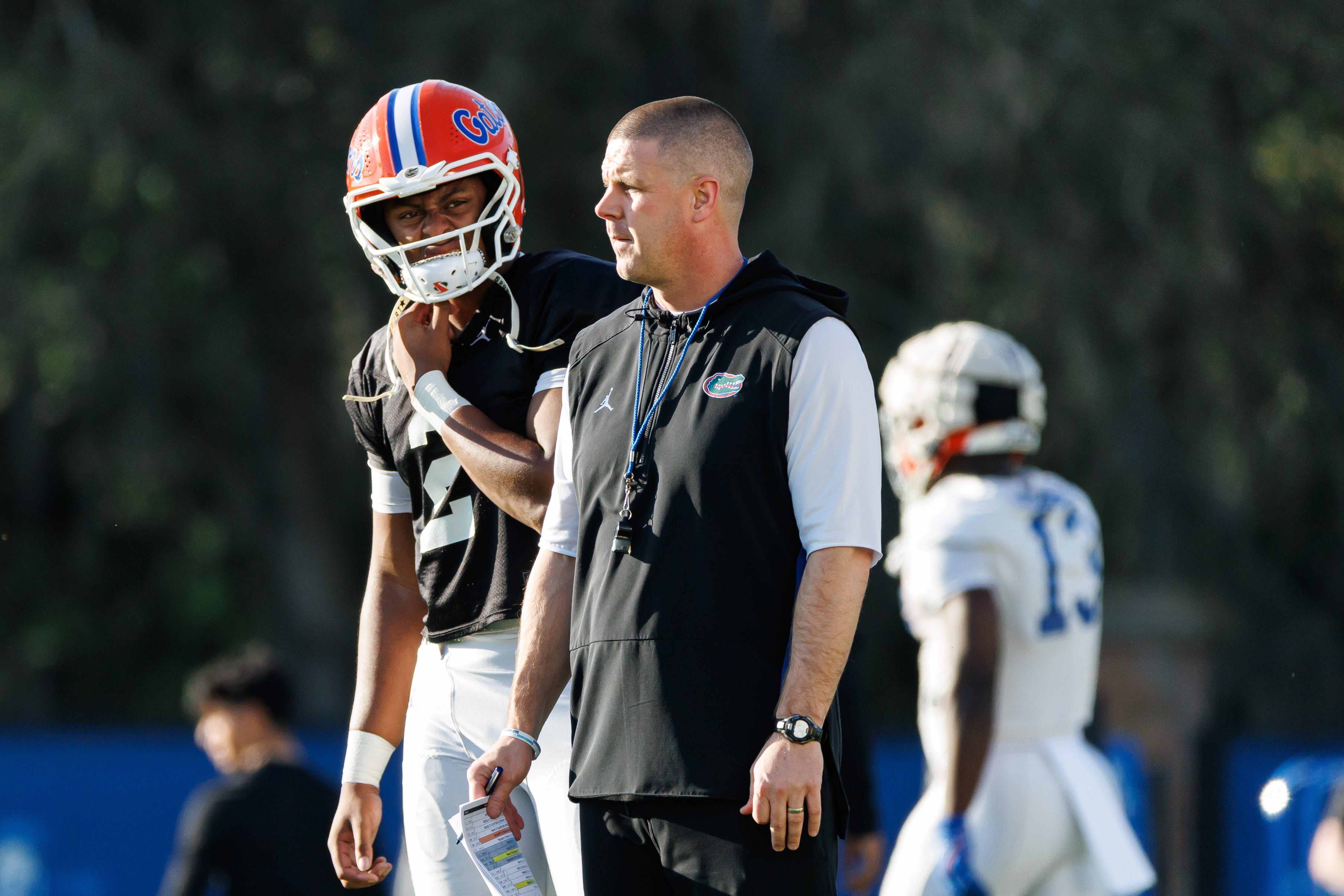 Florida Gators quarterback DJ Lagway (2) and Florida Gators head coach Billy Napier watch during spring football practice at Heavener Football Complex at the University of Florida in Gainesville, FL on Thursday, March 6, 2025.