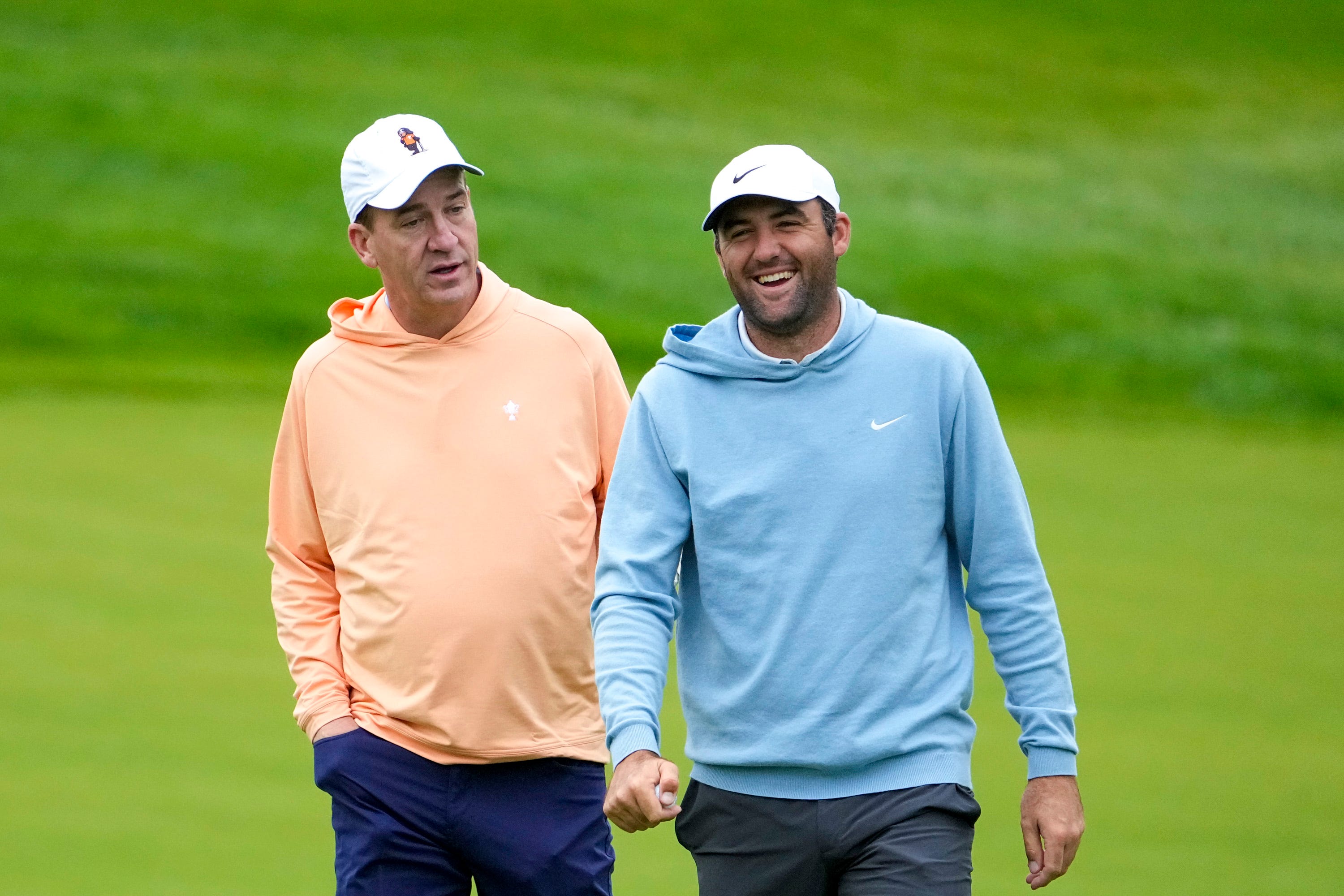 Peyton Manning makes Scottie Scheffler laugh as they walk to hole No. 4 during the Workday Golden Bear Pro-Am at the Muirfield Village Golf Club on Wednesday, May 28, 2025 in Dublin, Ohio.