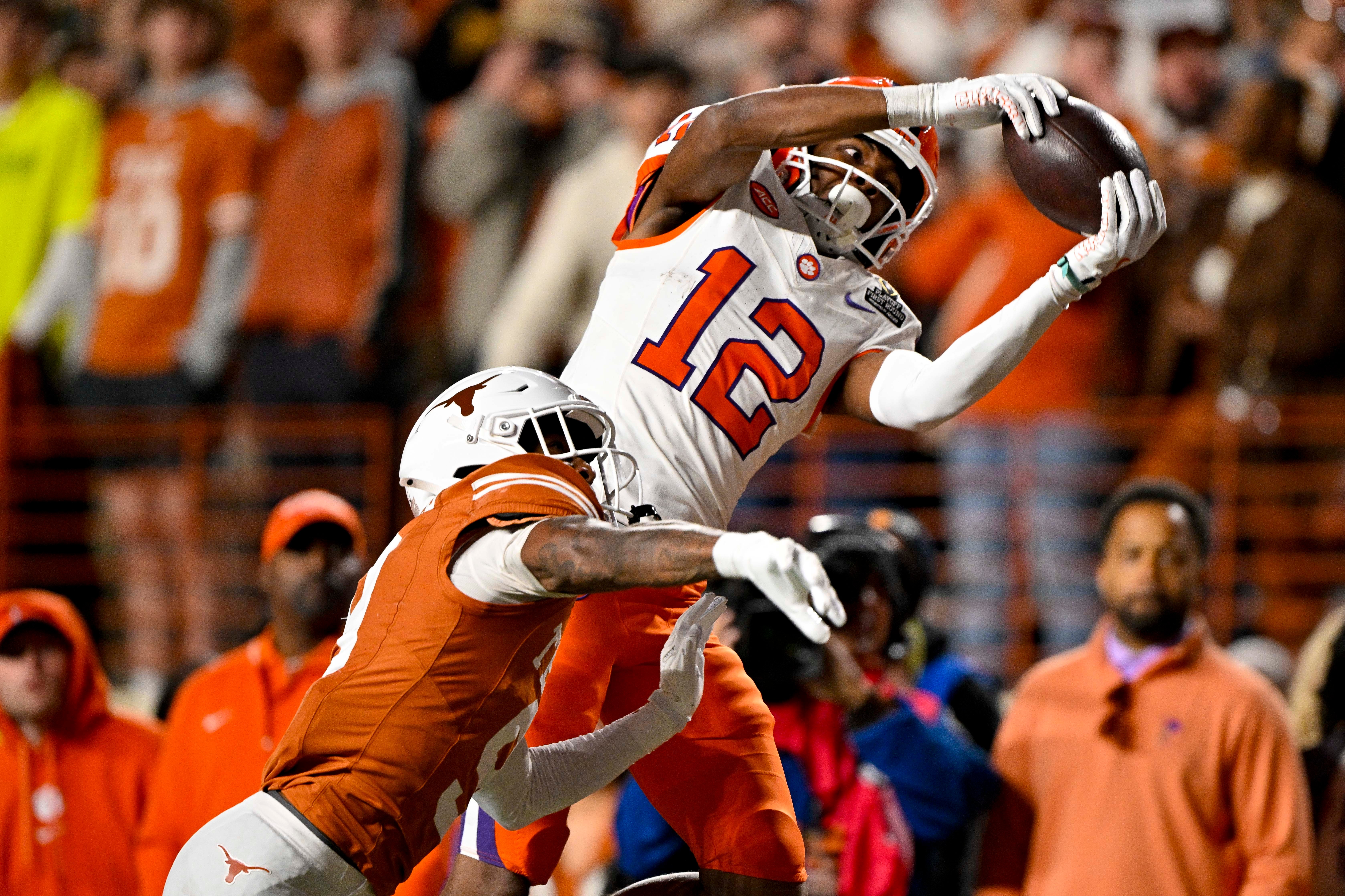 Dec 21, 2024; Austin, Texas, USA; Clemson Tigers wide receiver Bryant Wesco Jr. (12) attempts to catch a pass of Texas Longhorns defensive back Gavin Holmes (9) during the second half of the CFP National Playoff first round game at Darrell K Royal-Texas Memorial Stadium. Mandatory Credit: Jerome Miron-Imagn Images