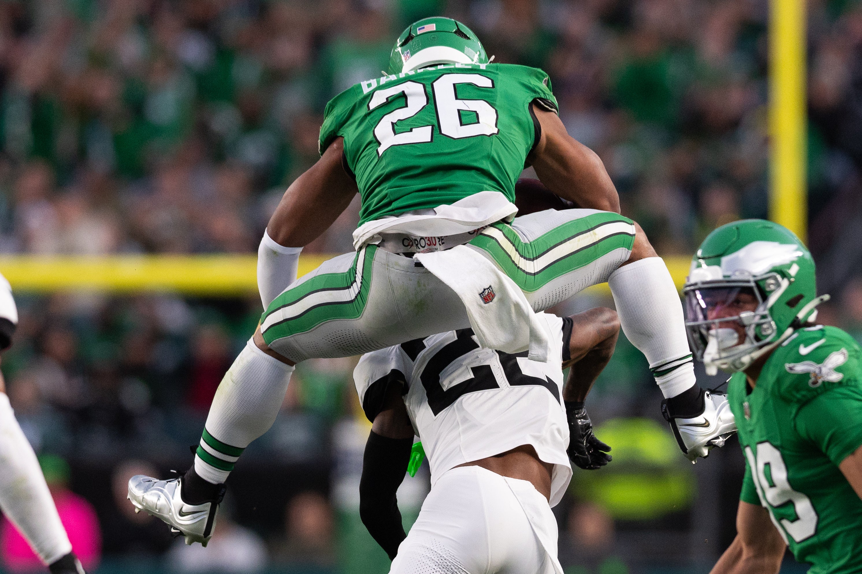 Philadelphia Eagles running back Saquon Barkley (26) leaps with the ball over Jacksonville Jaguars cornerback Jarrian Jones (22) during the second quarter at Lincoln Financial Field.