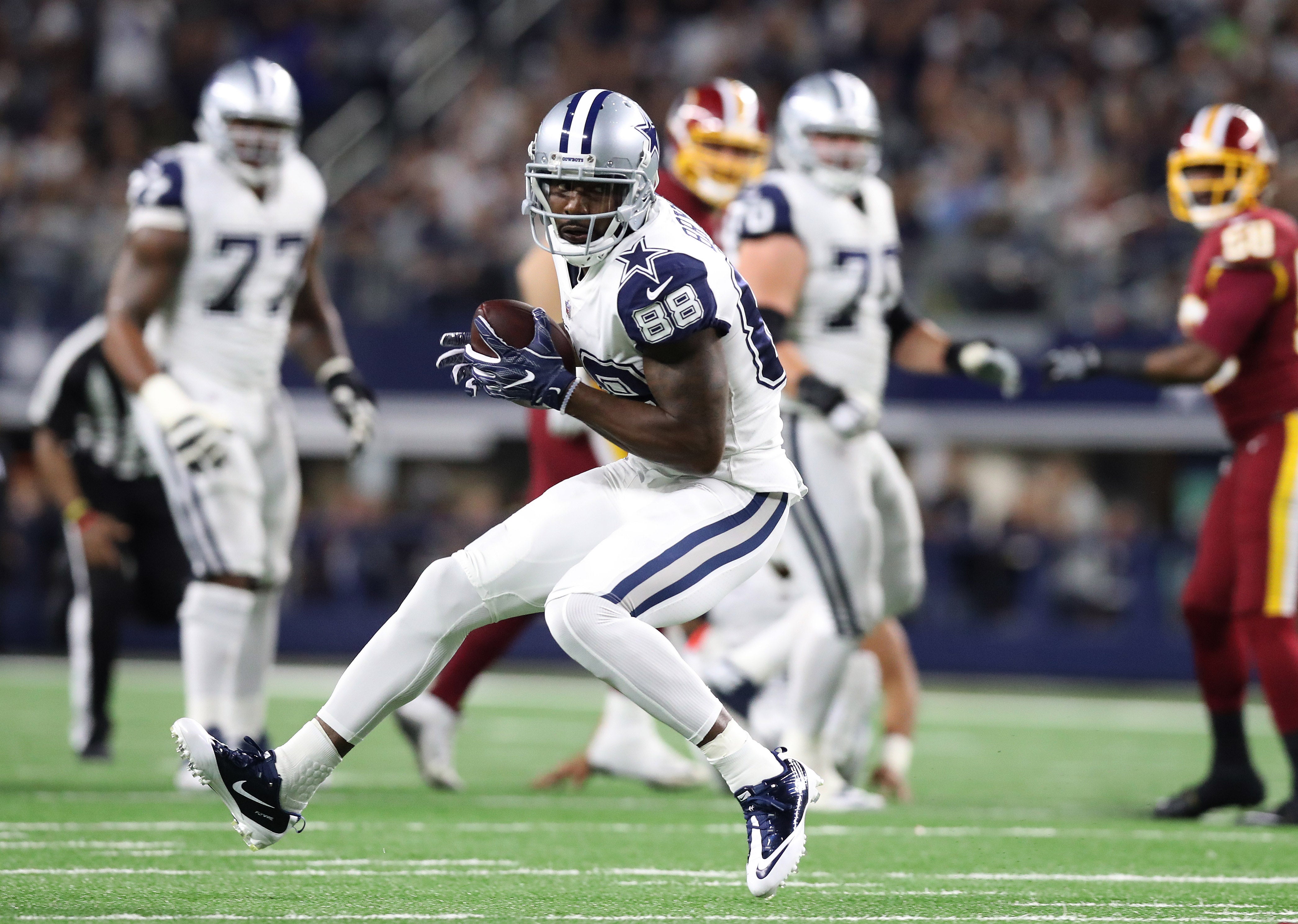 Dallas Cowboys wide receiver Dez Bryant (88) runs after a reception in the second quarter against the Washington Redskins at AT&T Stadium.