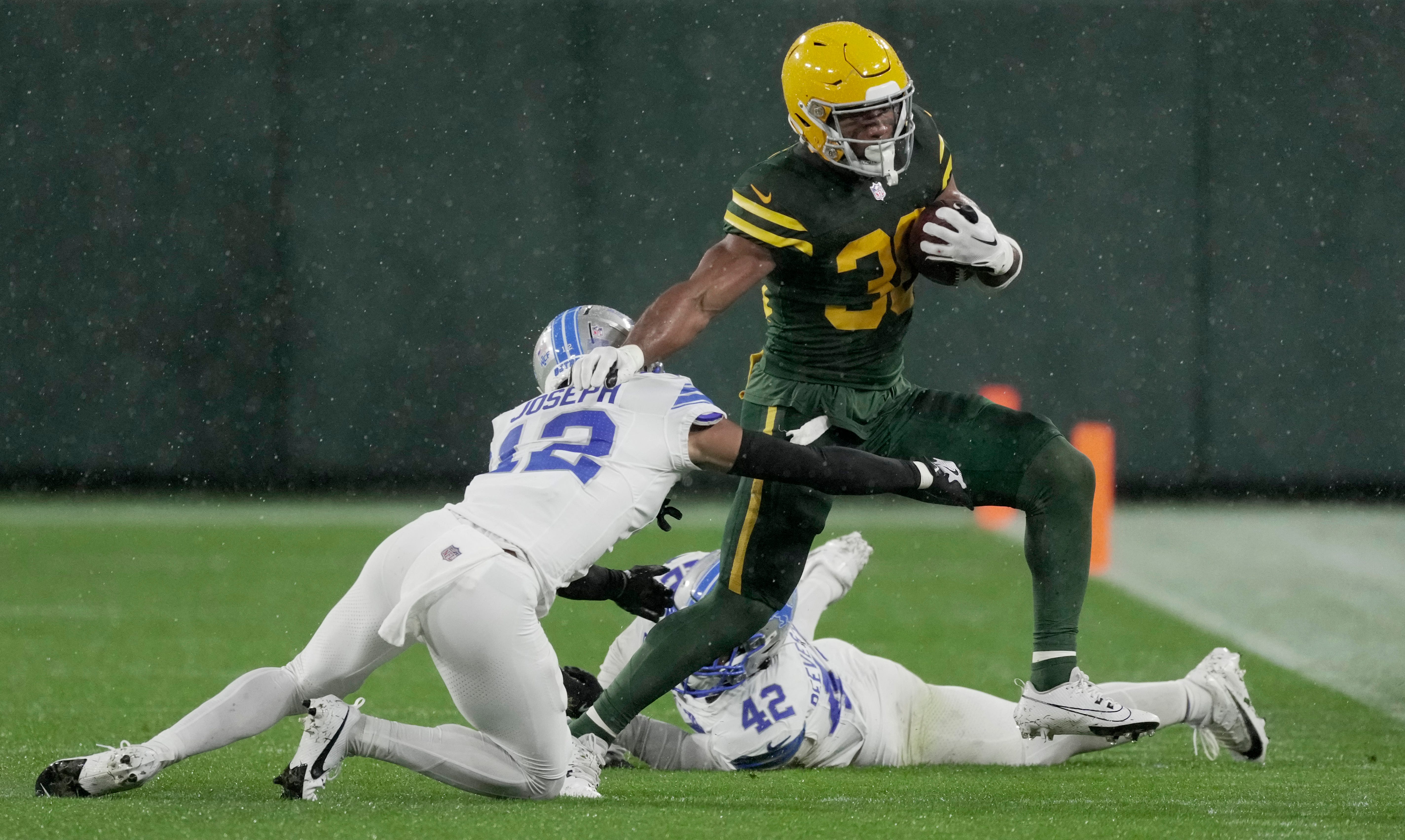 Green Bay Packers running back Chris Brooks (30) picks up some yardage during the second quarter of their game against the Detroit Lions Sunday, November 3, 2024, at Lambeau Field in Green Bay, Wisconsin.