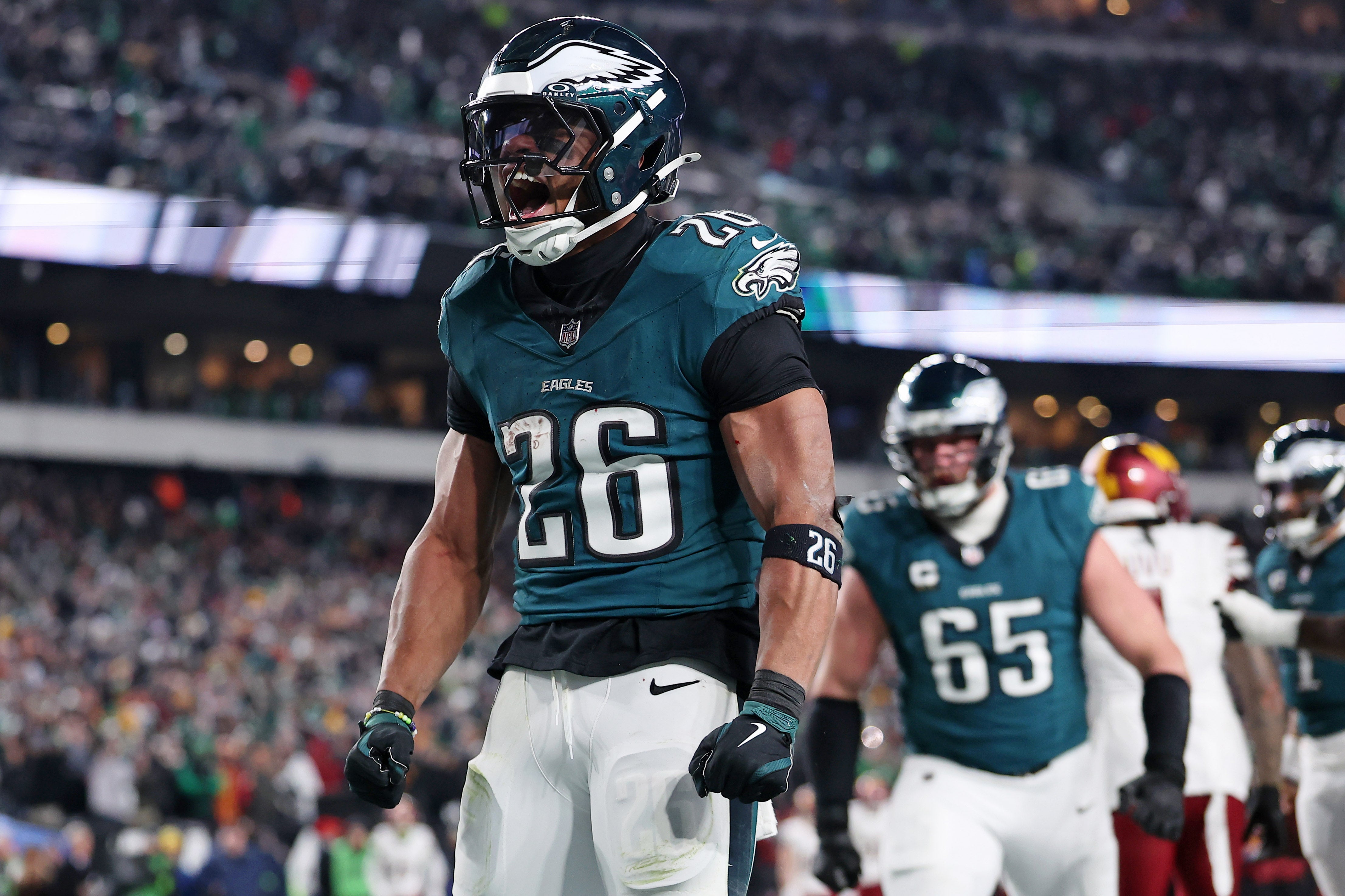 Philadelphia Eagles running back Saquon Barkley (26) celebrates after a touchdown against the Washington Commanders during the second half in the NFC Championship game at Lincoln Financial Field.