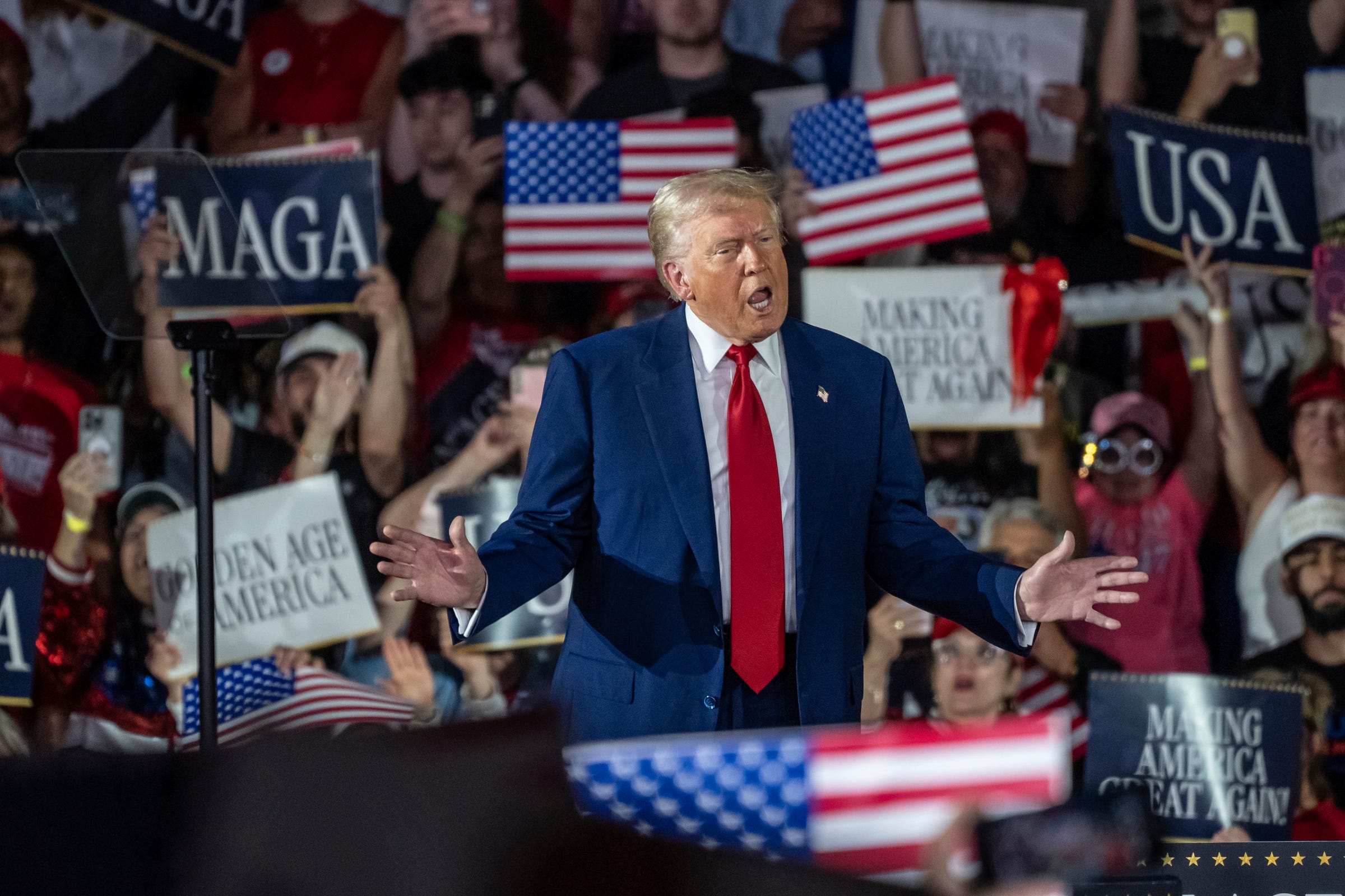 President Donald Trump takes the stage to speak to a crowd during his 100TH Day in Office Achievement Rally at the Macomb on Tuesday, April 29, 2025.