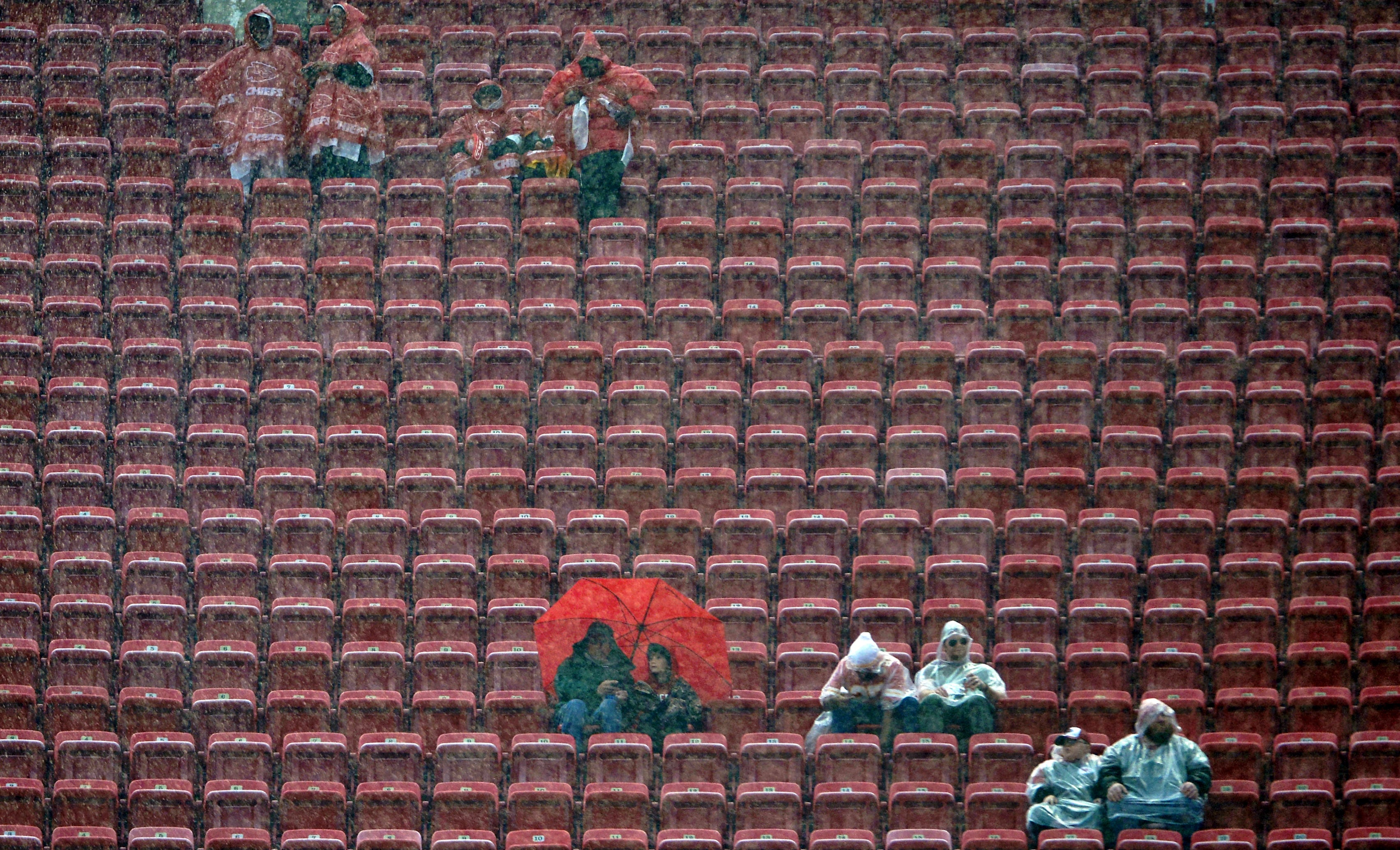 Dec 13, 2015; Kansas City, MO, USA; Fans watch team warmups in the rain before the game between the Kansas City Chiefs and San Diego Chargers at Arrowhead Stadium.
