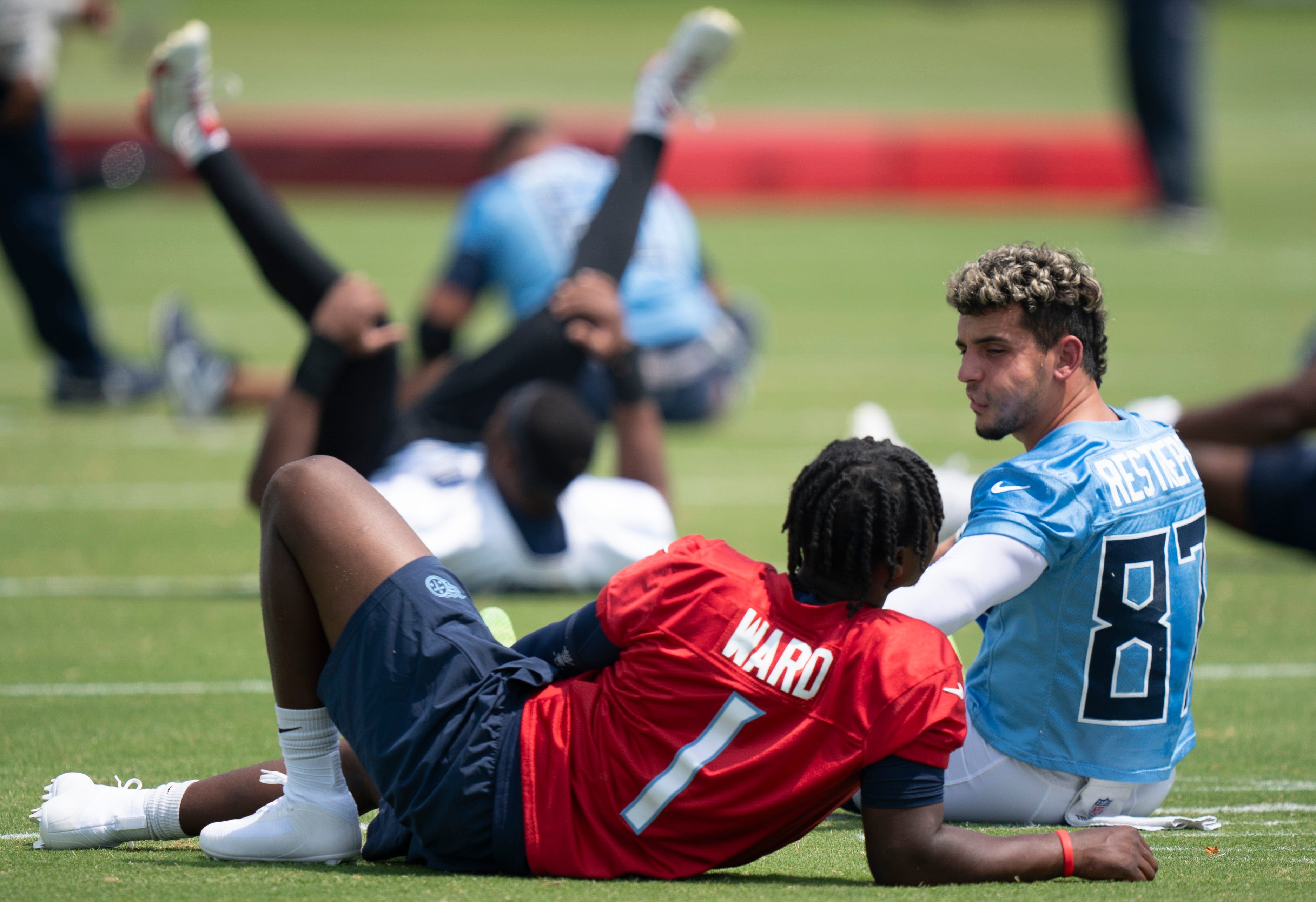 Tennessee Titans quarterback Cam Ward (1) and wide receiver Xavier Restrepo (87) stretch during OTAs at Ascension Saint Thomas Sports Park in Nashville, Tenn., Tuesday, June 3, 2025.