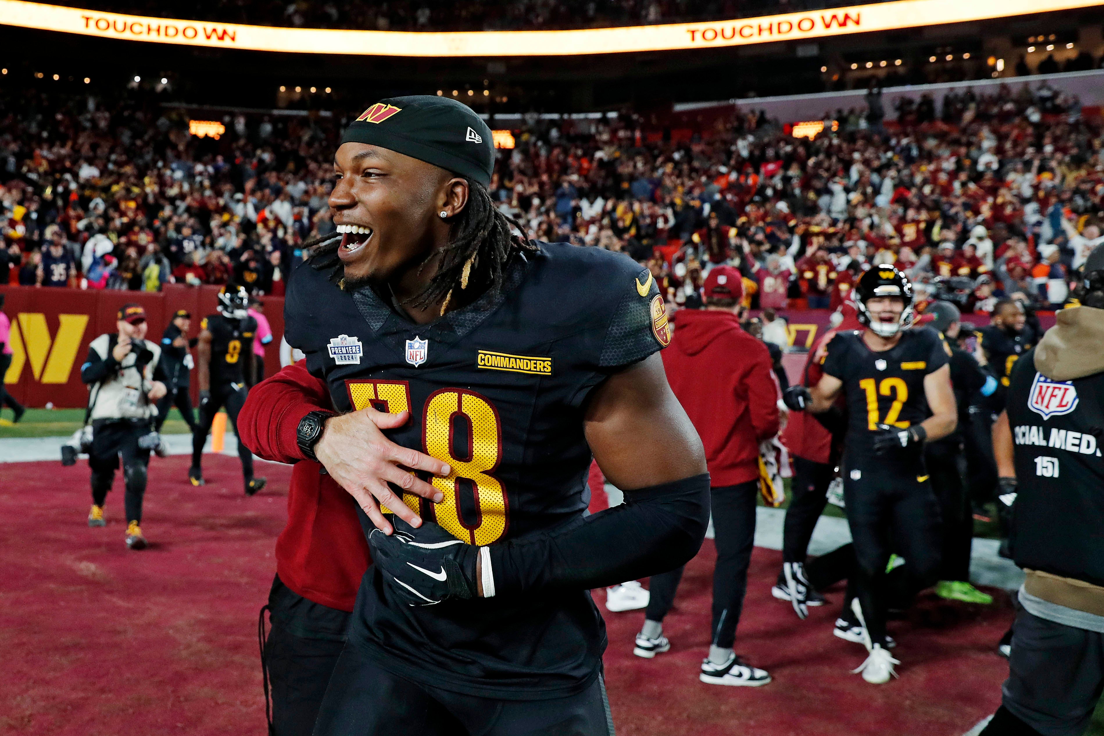 Oct 27, 2024; Landover, Maryland, USA; Washington Commanders linebacker Jordan Magee (58) celebrates after the Washington Commanders beat the Chicago Bears on a Hail Mary pass with no time left at Commanders Field.