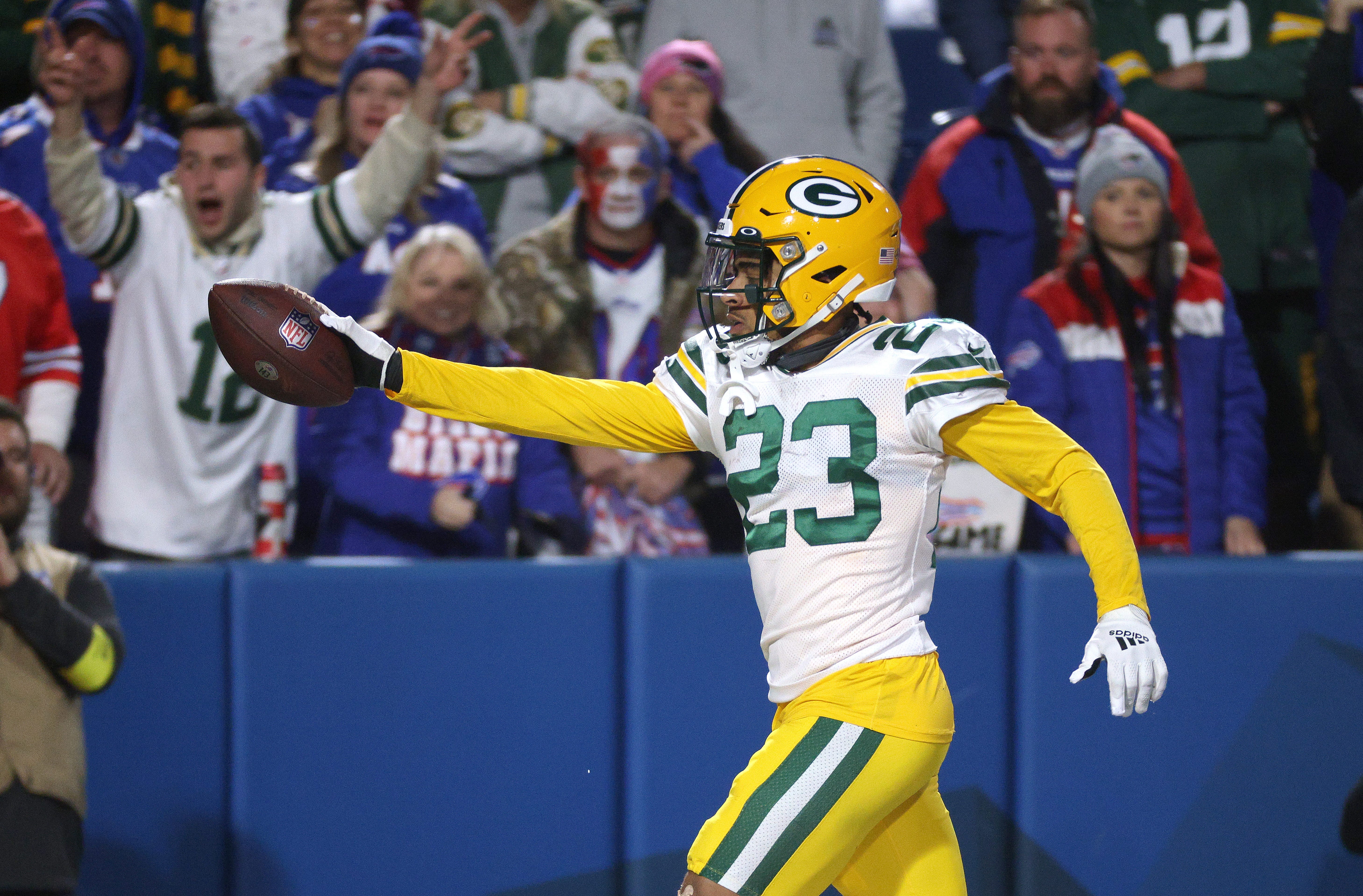 Packers cornerback Jaire Alexander gives the ball to a fan after his interception against the Bills.