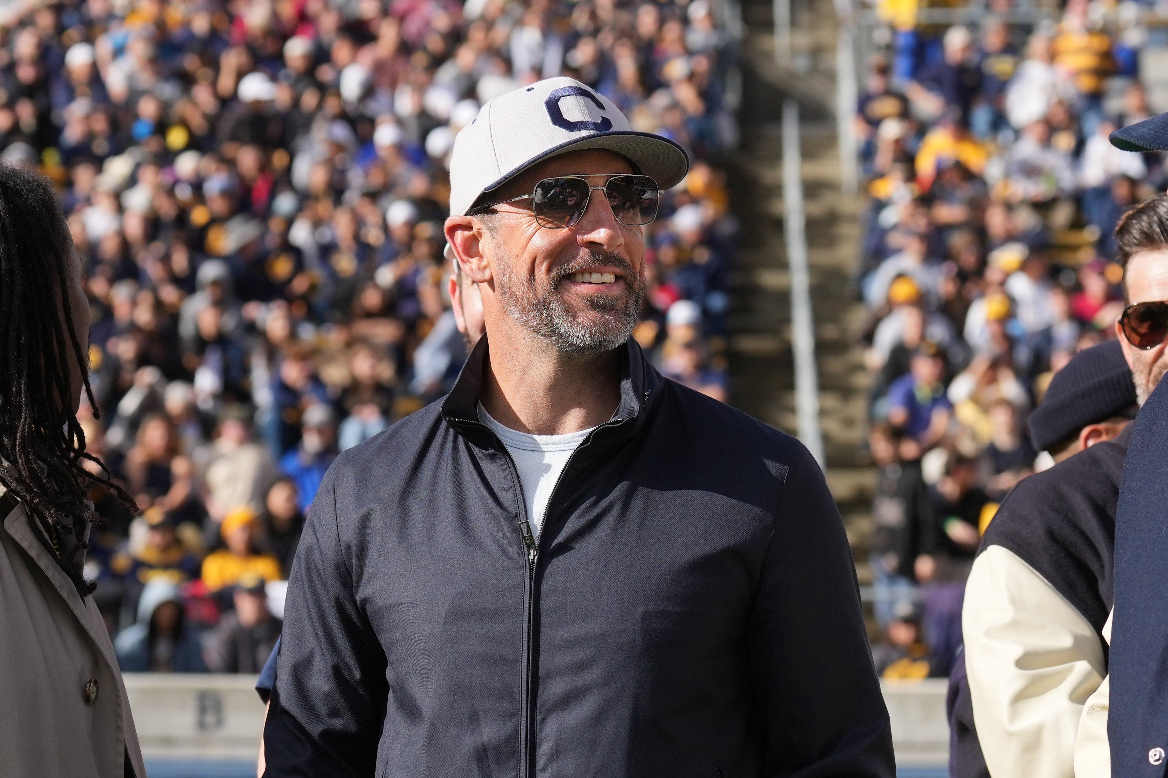 Nov 23, 2024; Berkeley, California, USA; California Golden Bears former quarterback Aaron Rodgers stands on the field before the start of the second quarter against the Stanford Cardinal at California Memorial Stadium.